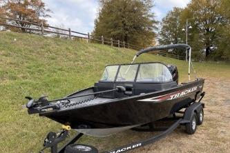 2026 Tracker Pro Guide V-175 WT boat on trailer, parked outdoors.