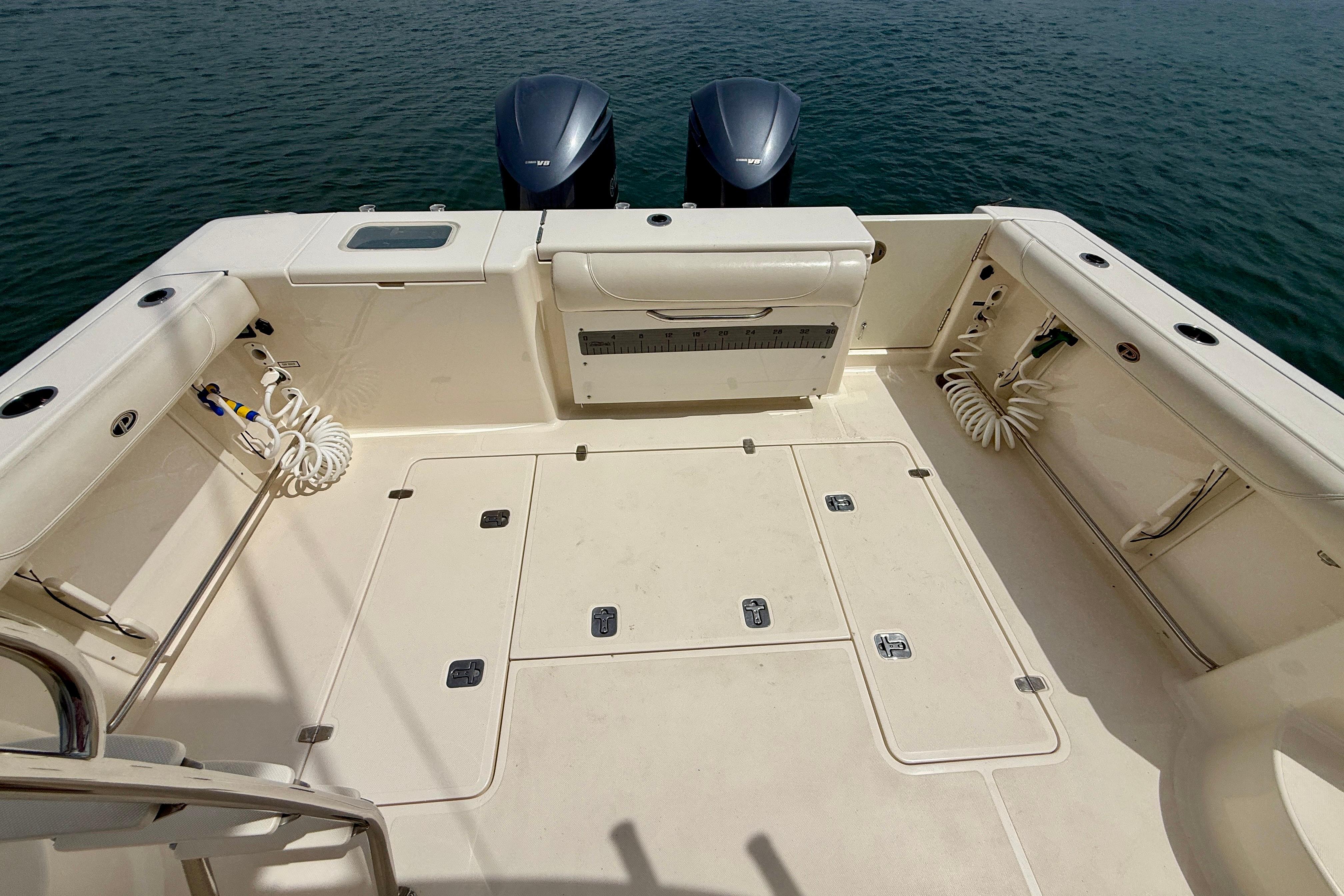 2012 Pursuit OS 345 Offshore boat deck with twin engines on water.