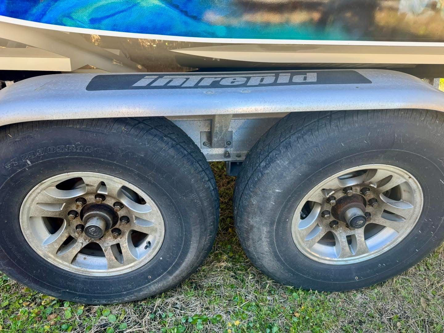 Intrepid 327 Nomad 2021 trailer wheels on grassy area.