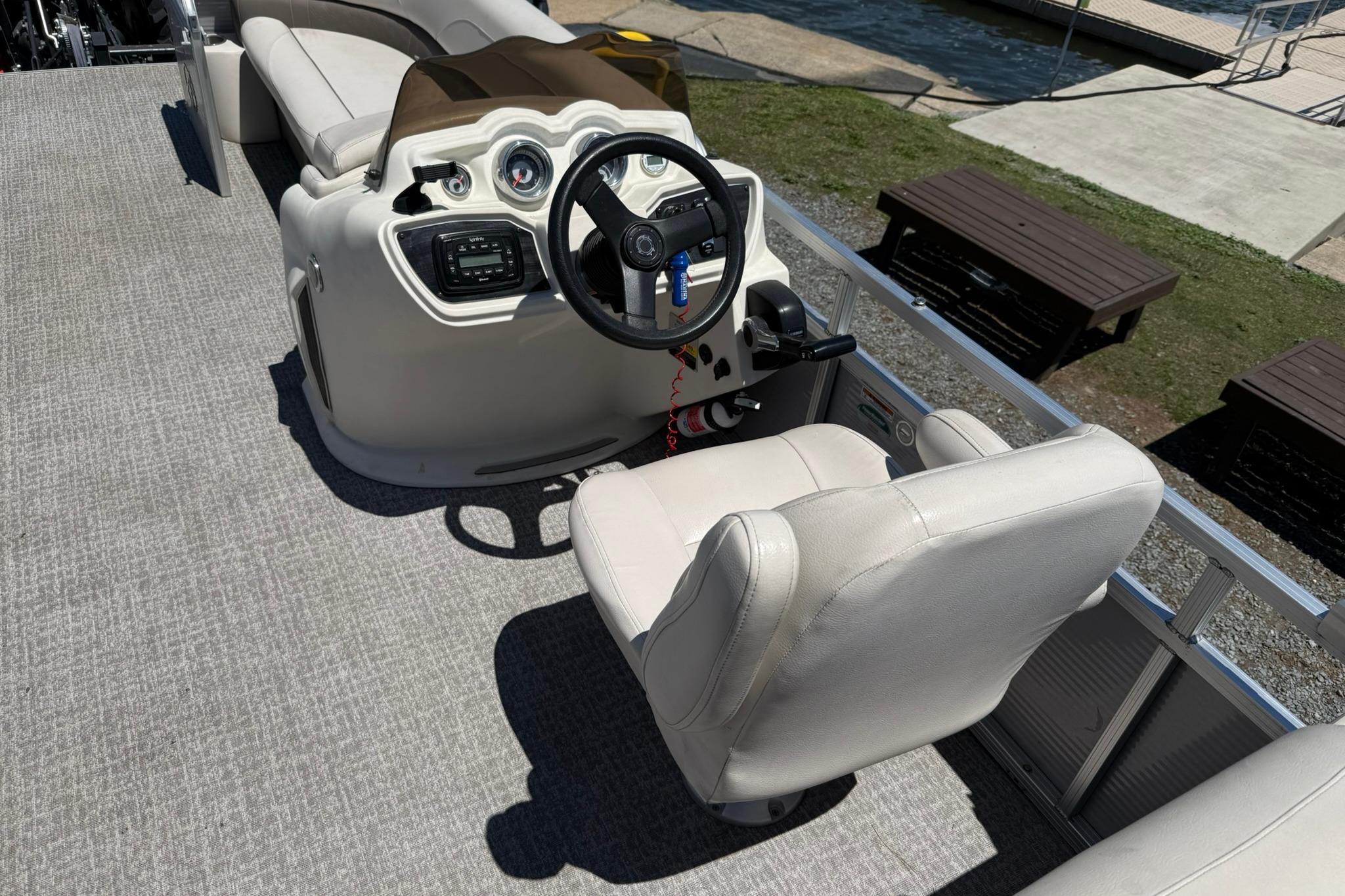 2019 Avalon GS Quad Lounge boat interior with steering console and seating.