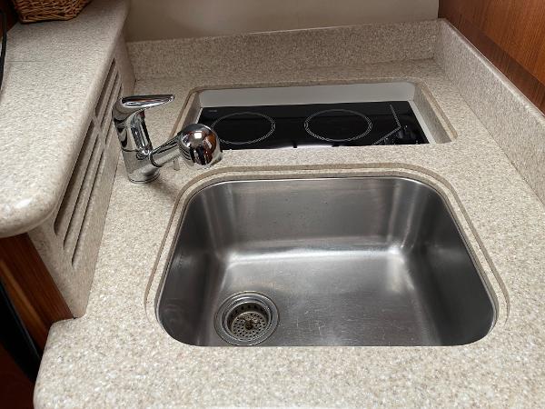 2003 Tiara Yachts 3500 Open kitchen sink and stove in compact galley area.