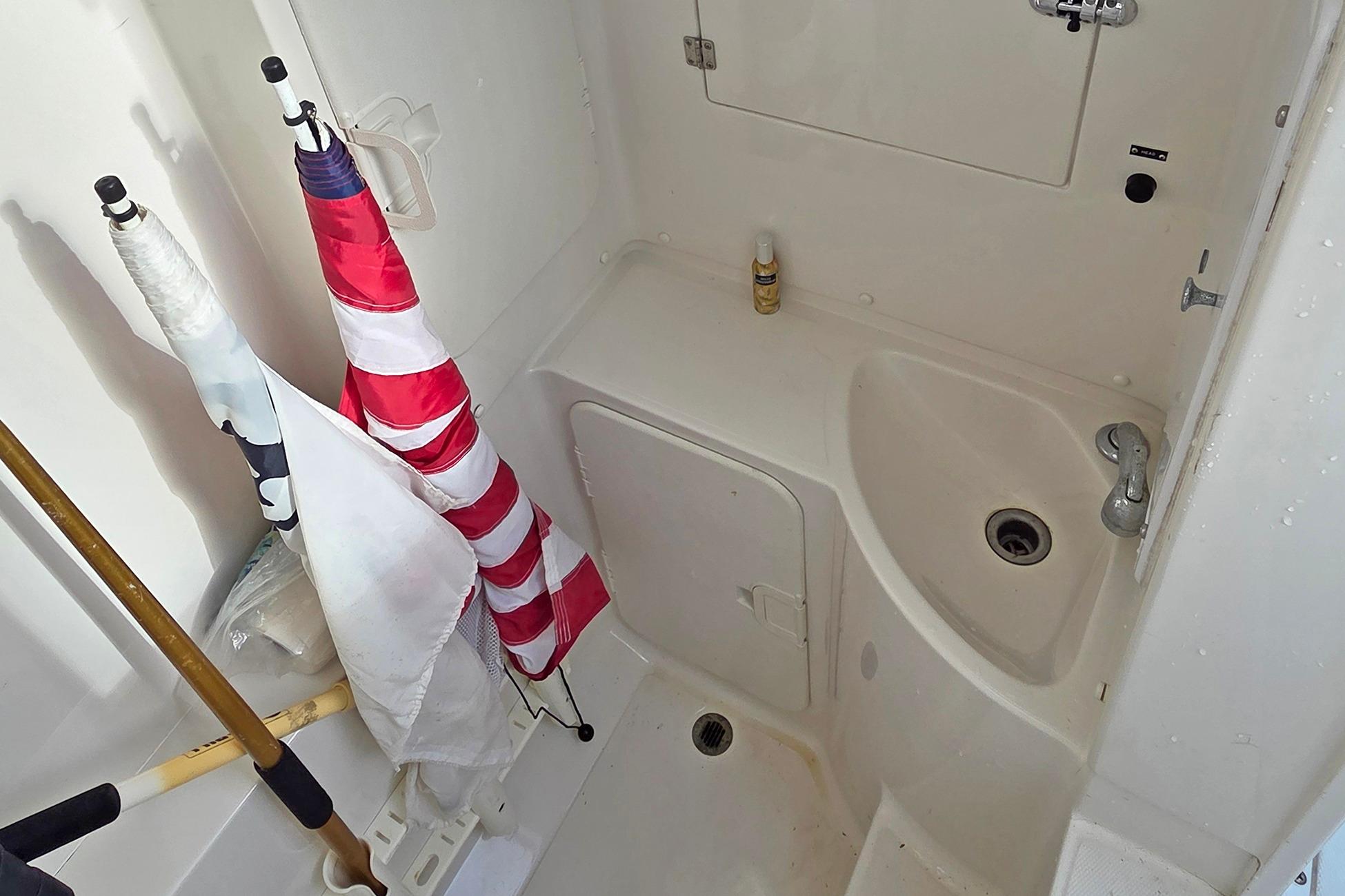 2001 Jupiter 31 Cuddy boat interior with sink and storage area.