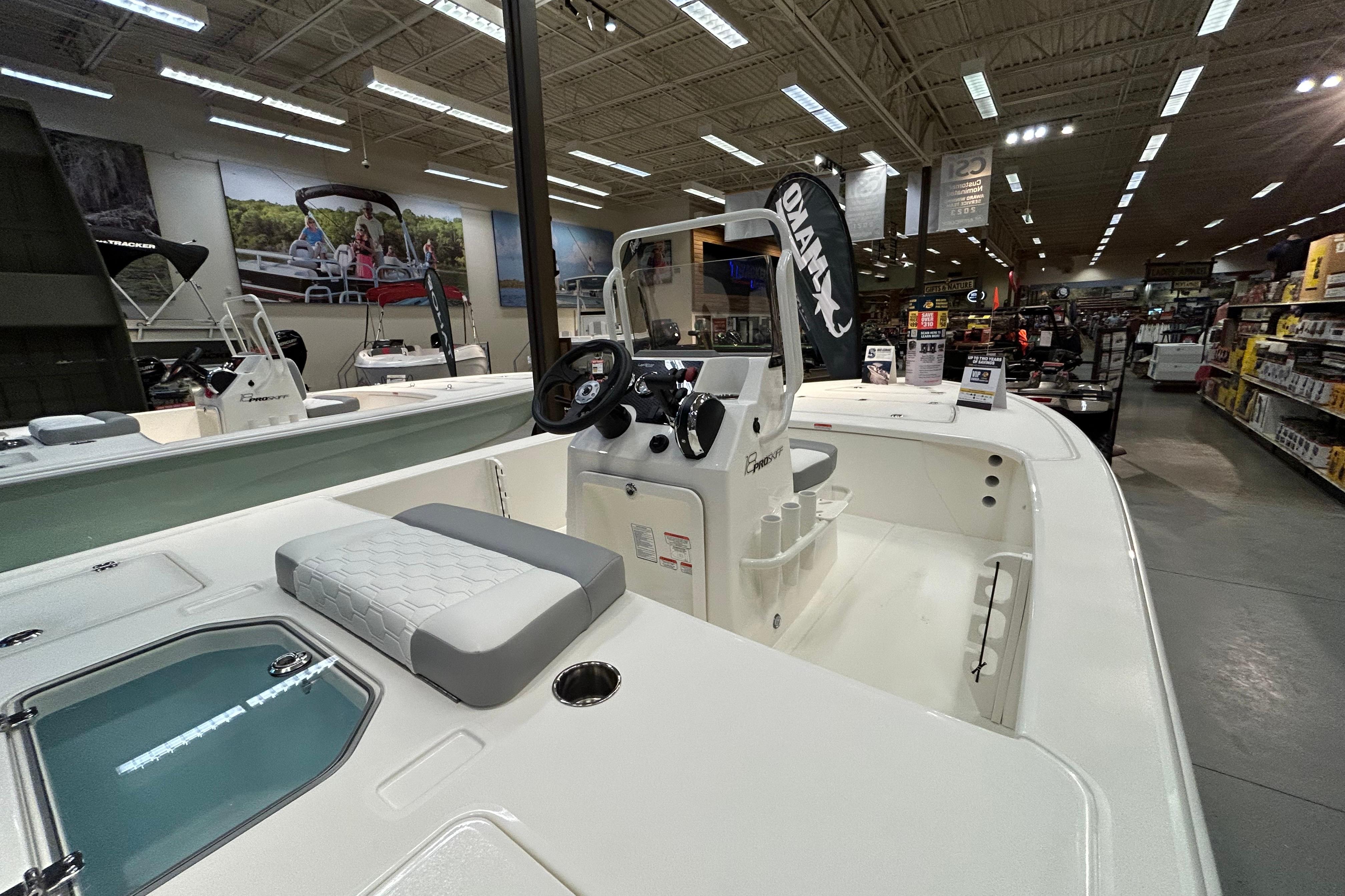 2026 Mako 18 Pro Skiff displayed in a showroom with modern interior features.