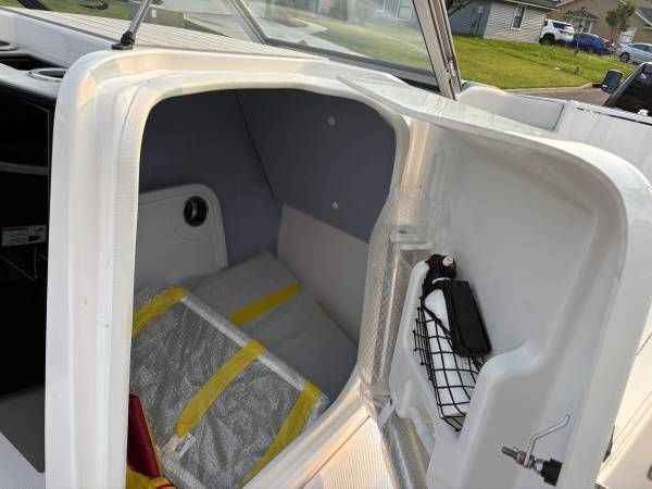 Interior of a 2021 Yamaha Boats AR250 with storage space.