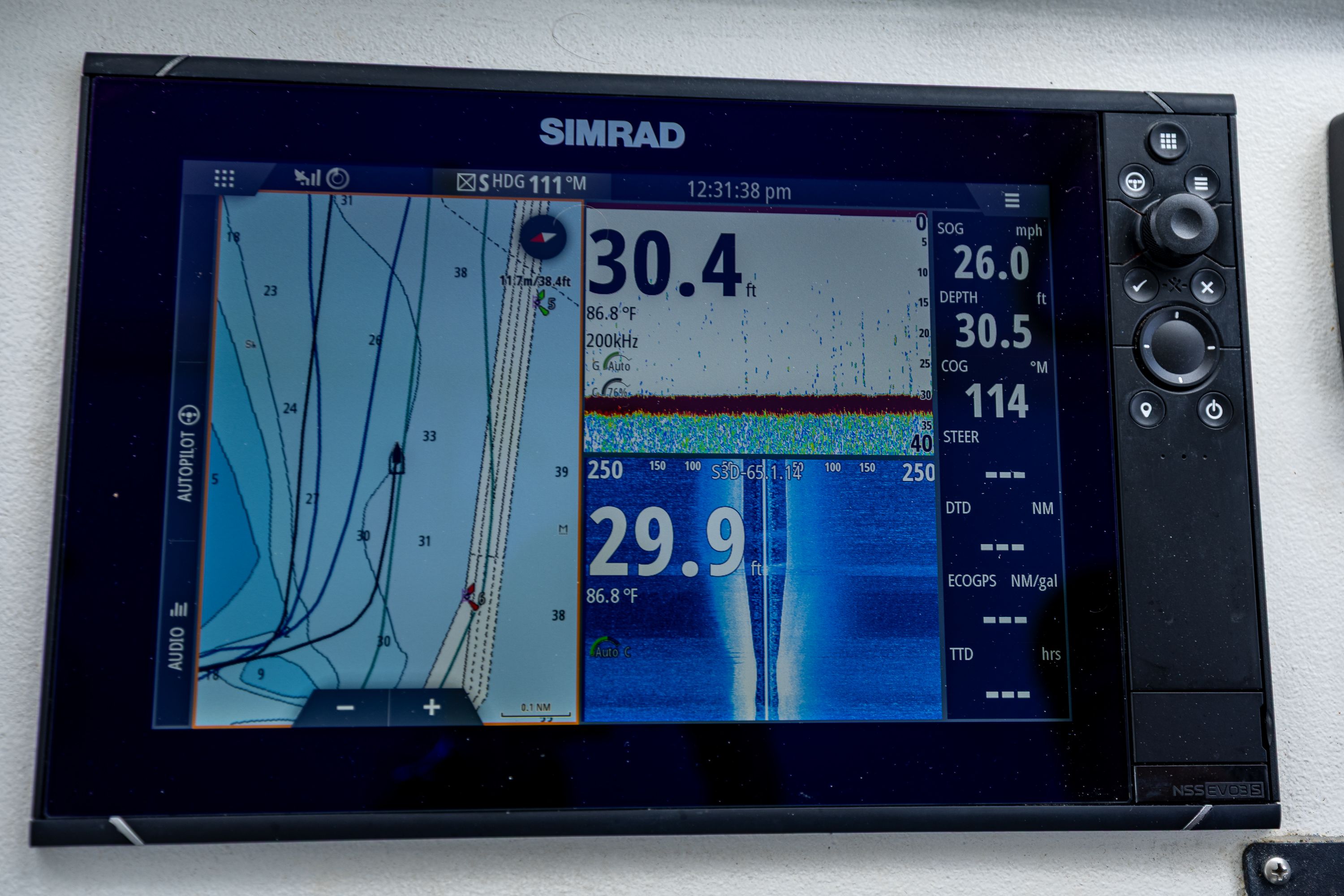 Simrad navigation system on a boat displaying depth and course information.