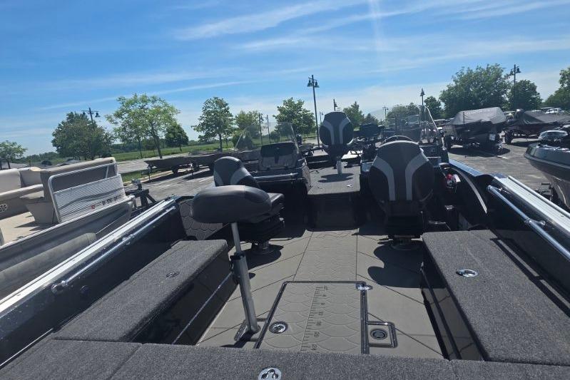 2026 Nitro ZV21 boat interior with seating and storage, parked outdoors under a clear sky.