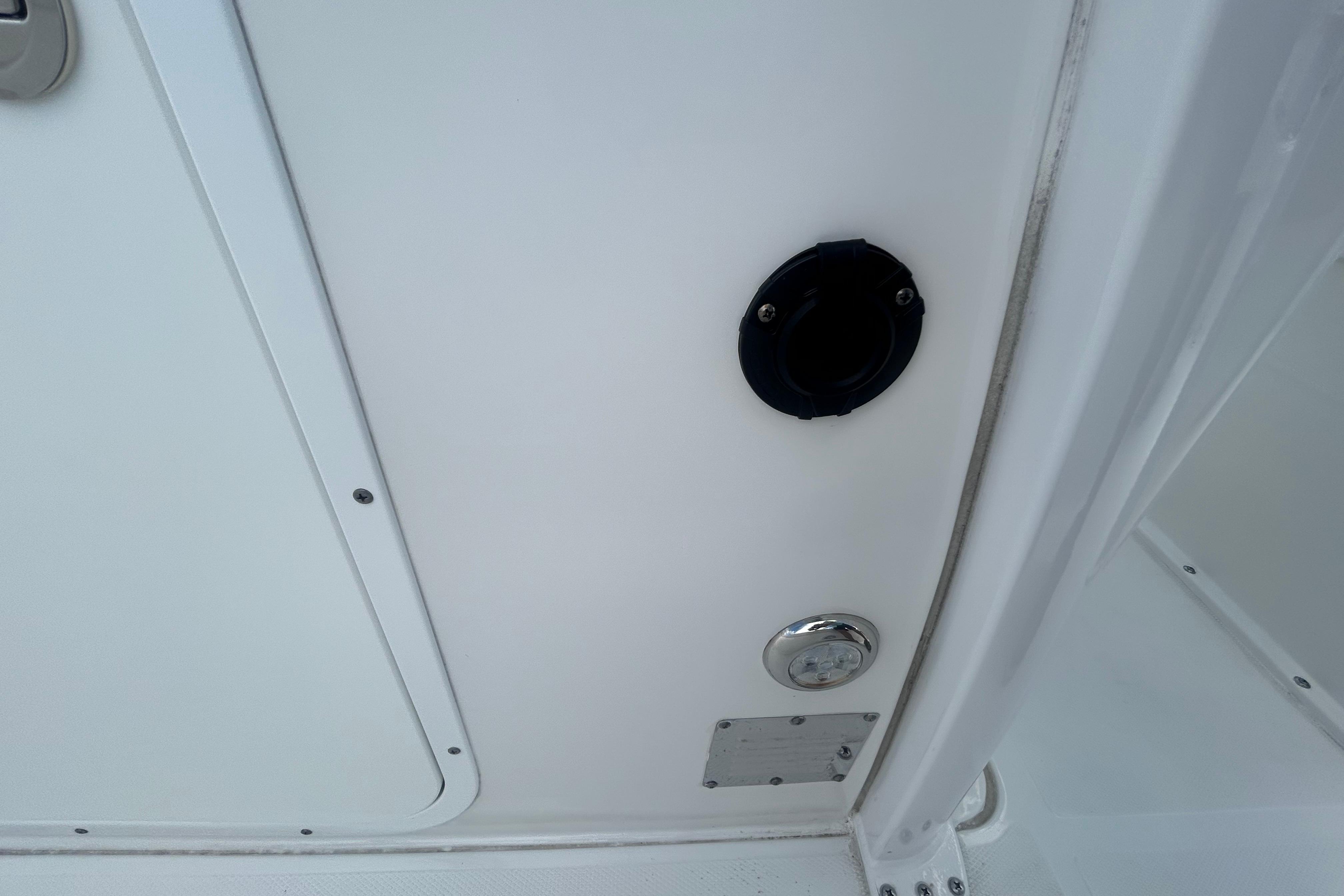 2023 Sea Hunt Gamefish 27 Coffin Box interior detail, featuring a white panel and fixtures.