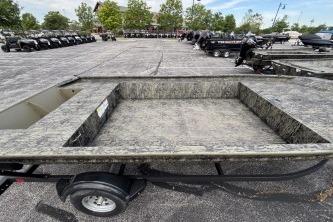2026 Tracker Grizzly 1860 Utility boat on trailer in parking lot.