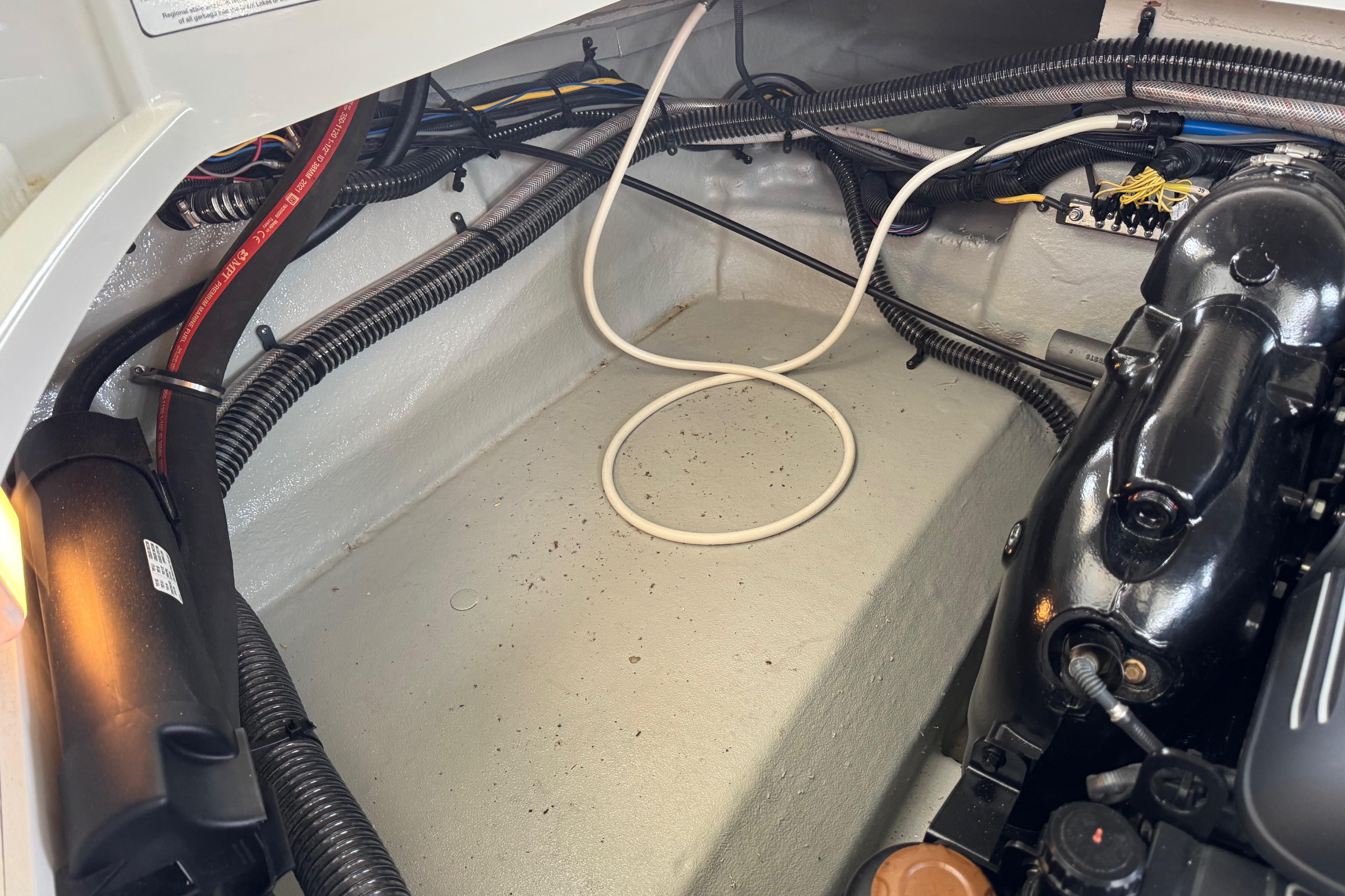 Engine compartment of 2022 Crownline 265 SS boat, showcasing wiring and components.