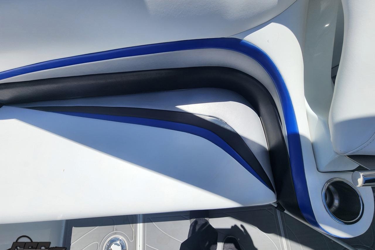 Interior of a 2008 Baja 335 Performance boat with sleek blue and black accents.