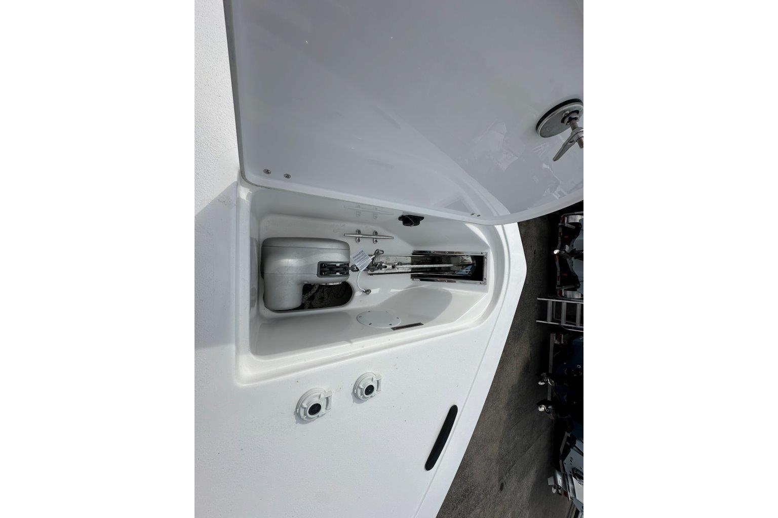 2026 Tidewater 272 LXF boat anchor compartment with open hatch, showcasing storage features.