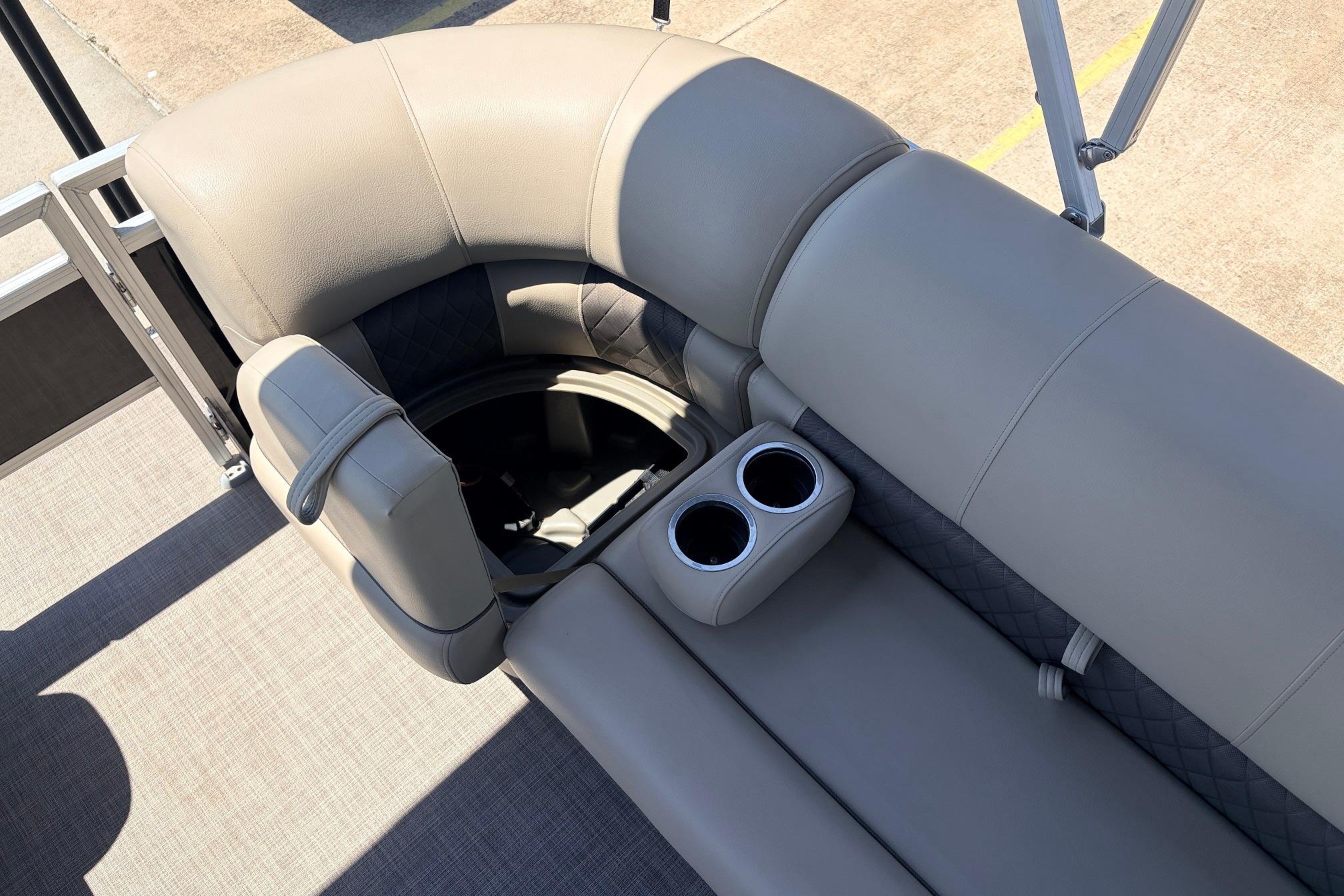 2024 Sun Tracker SportFish 22 XP3 boat interior with plush seating and cup holders.