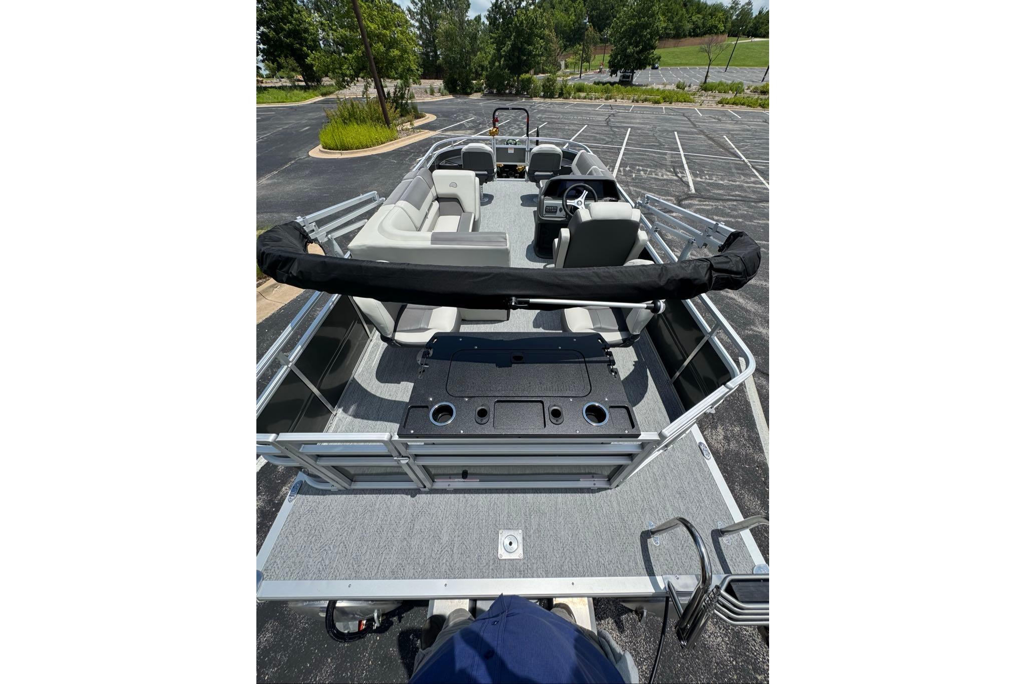 2026 Sun Tracker Fishin' Barge 20 DLX pontoon boat with spacious seating and fishing amenities.