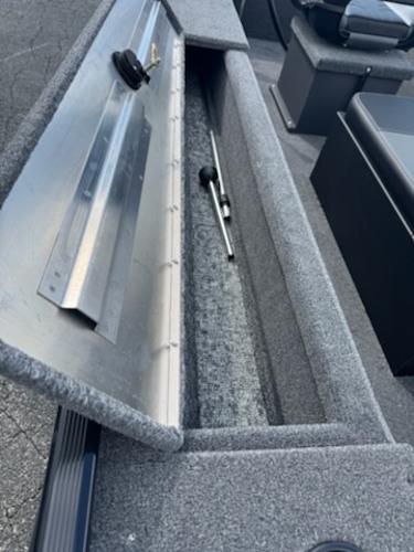 2025 Tracker Panfish 17 boat storage compartment with open lid, showcasing interior space.