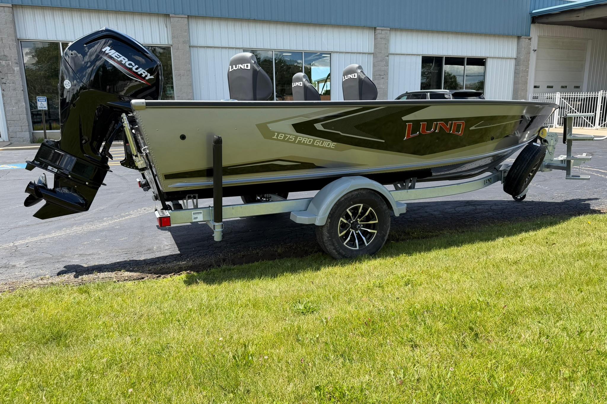 2027 Lund 1875 Pro Guide boat on trailer, featuring Mercury outboard motor.