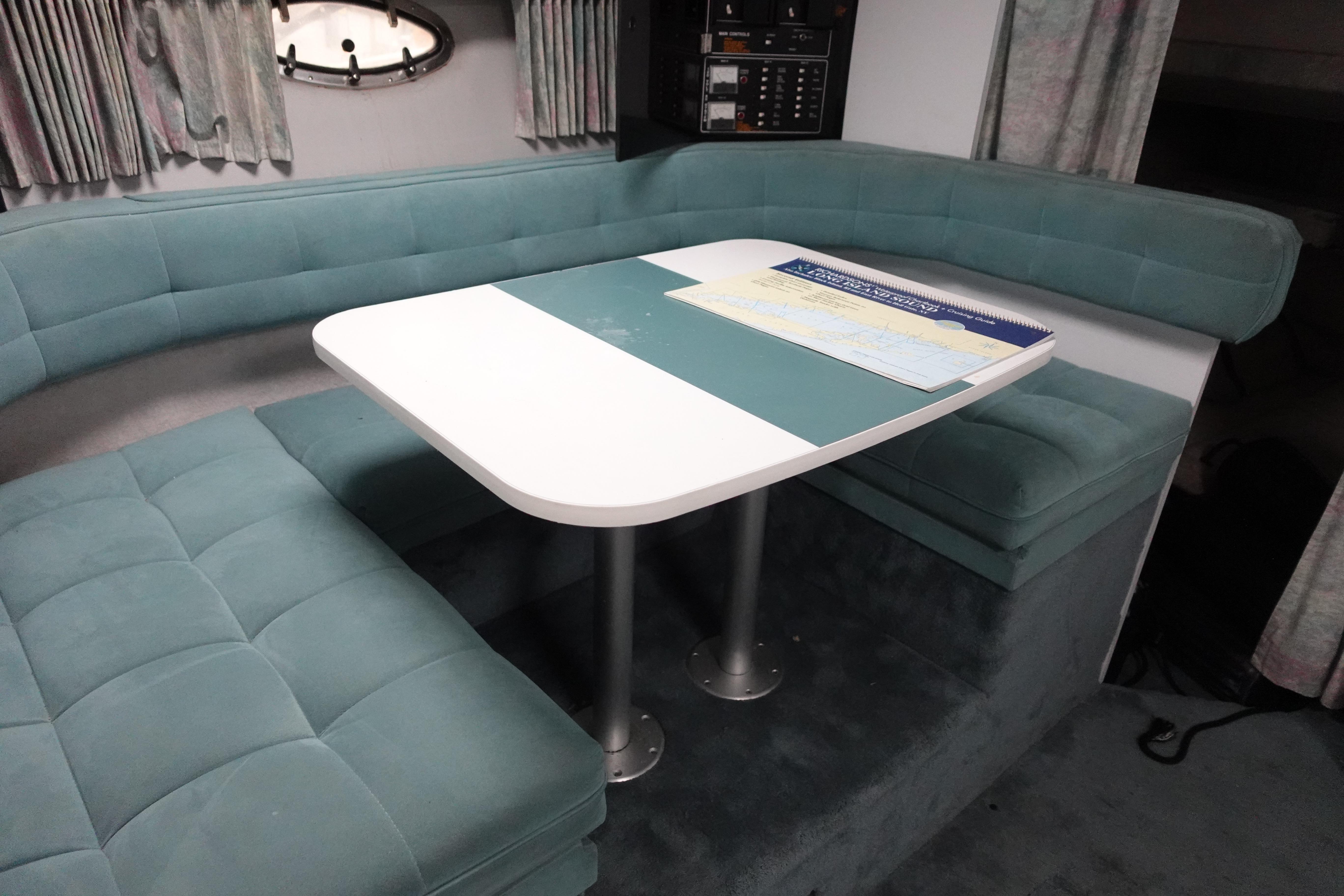 Interior of 1993 Formula 34 Performance Cruiser with teal seating and table.