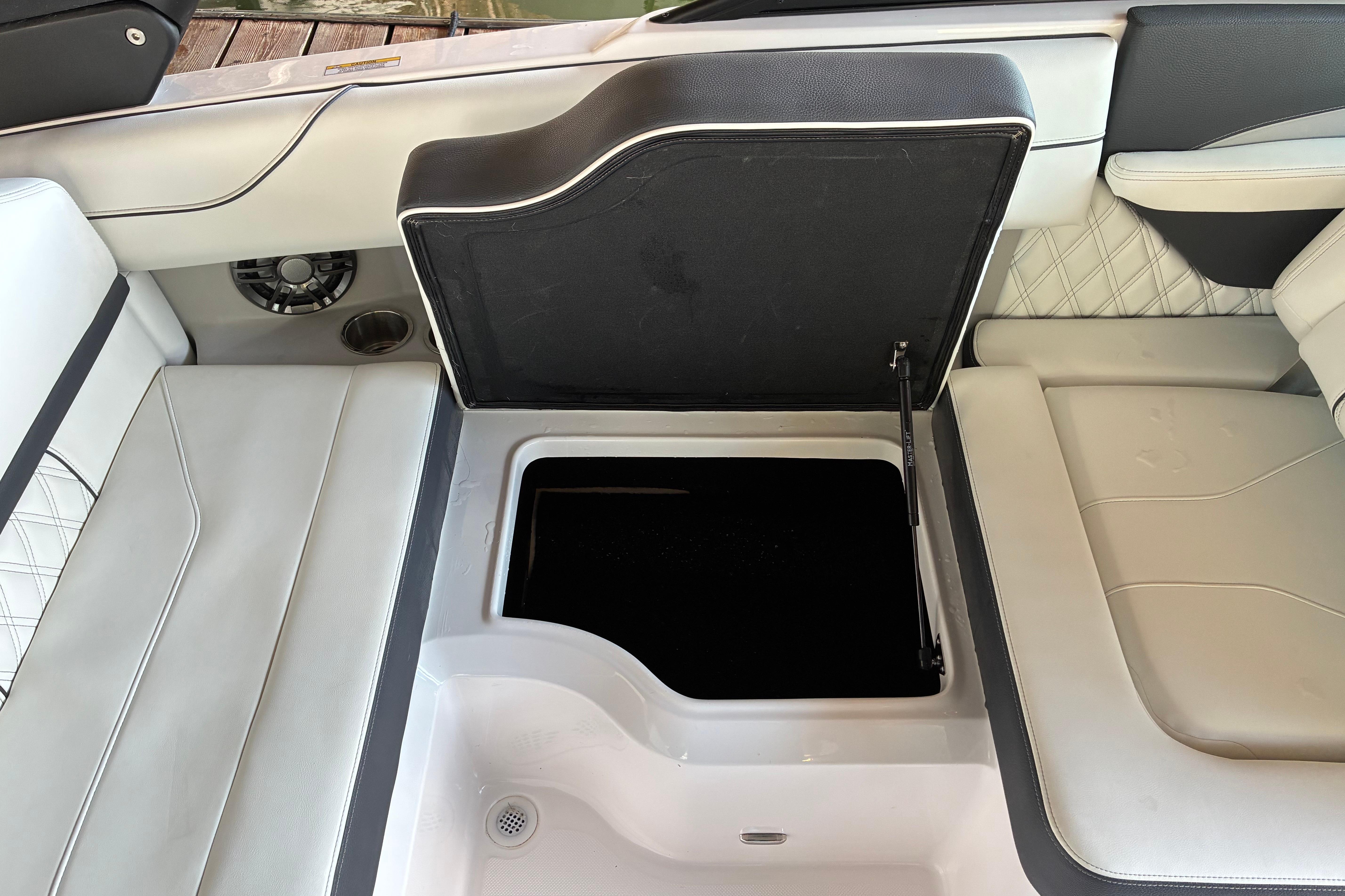2025 Regal LS2 boat interior with open storage compartment and cushioned seating.