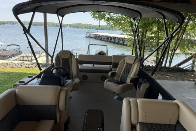 2025 Harris Sunliner 230 pontoon boat interior with lake view and comfortable seating.