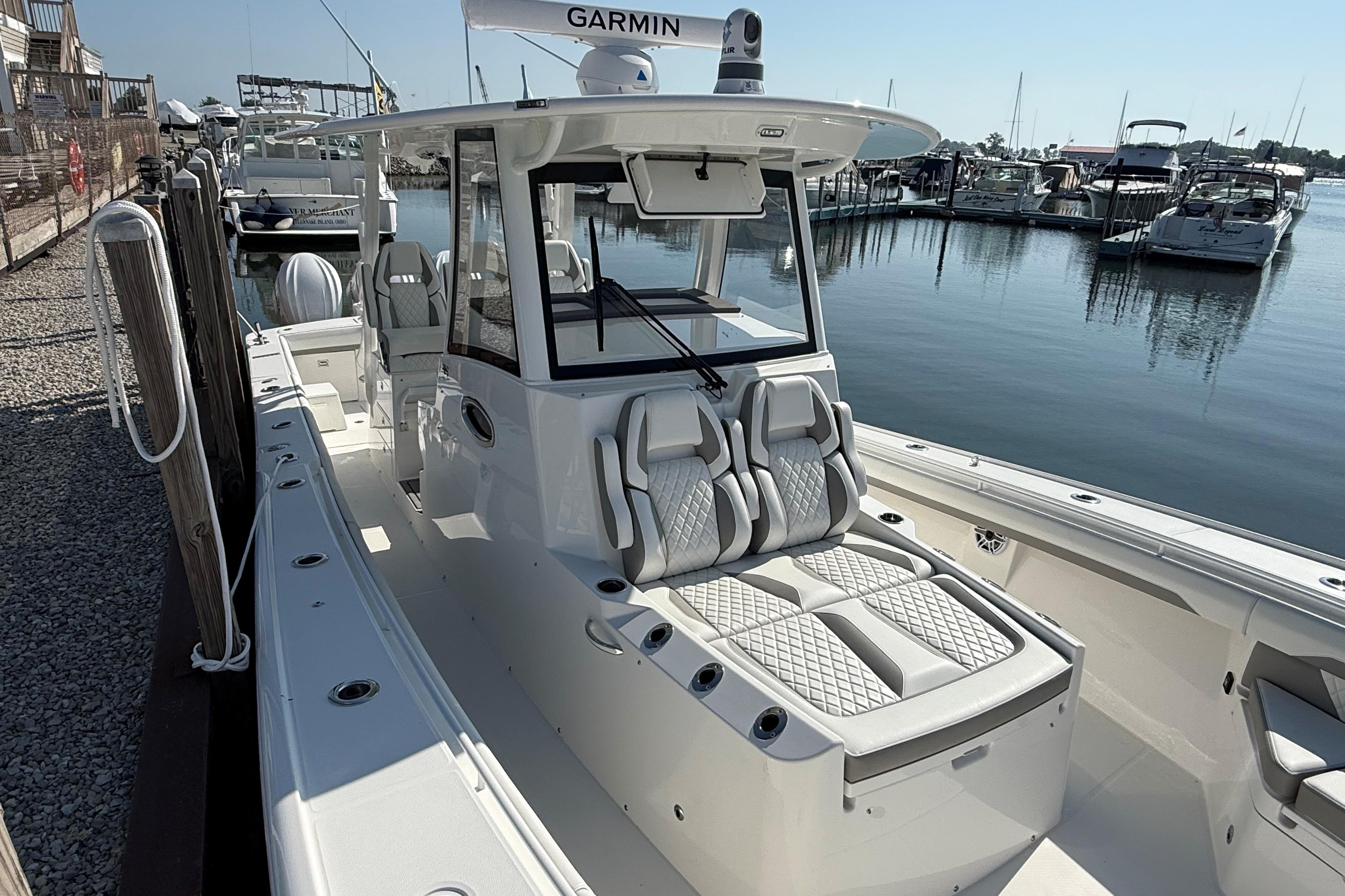 2026 Regulator 35 boat docked, featuring sleek design and modern seating in a marina setting.