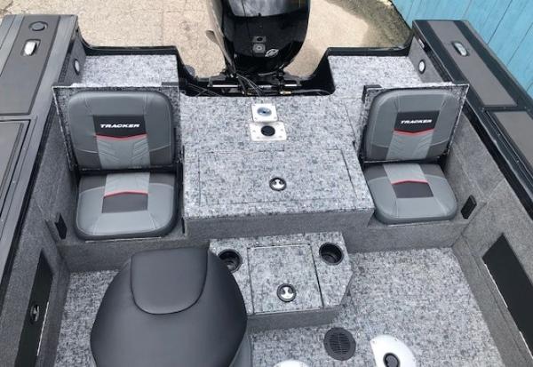 2025 Tracker Targa V18 Combo boat interior with gray seating and storage compartments.