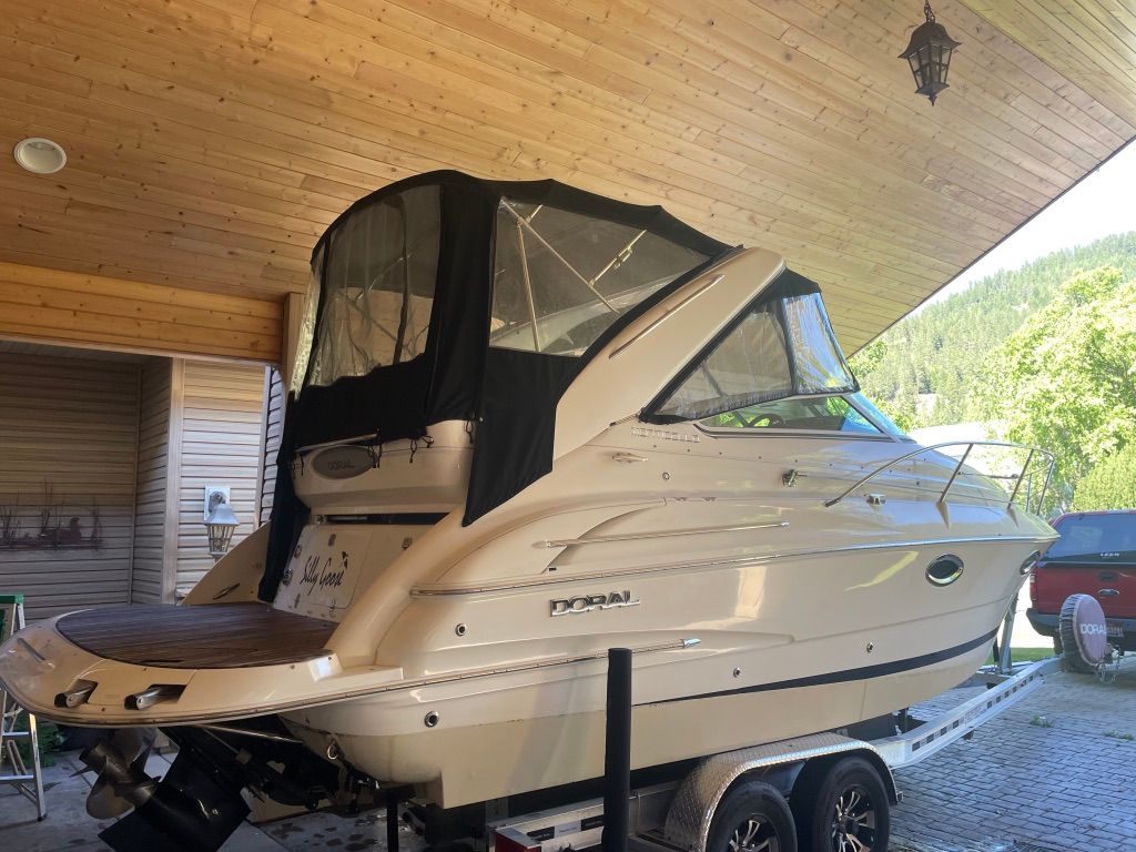 2007 Doral Monticello parked on a trailer under a wooden roof.