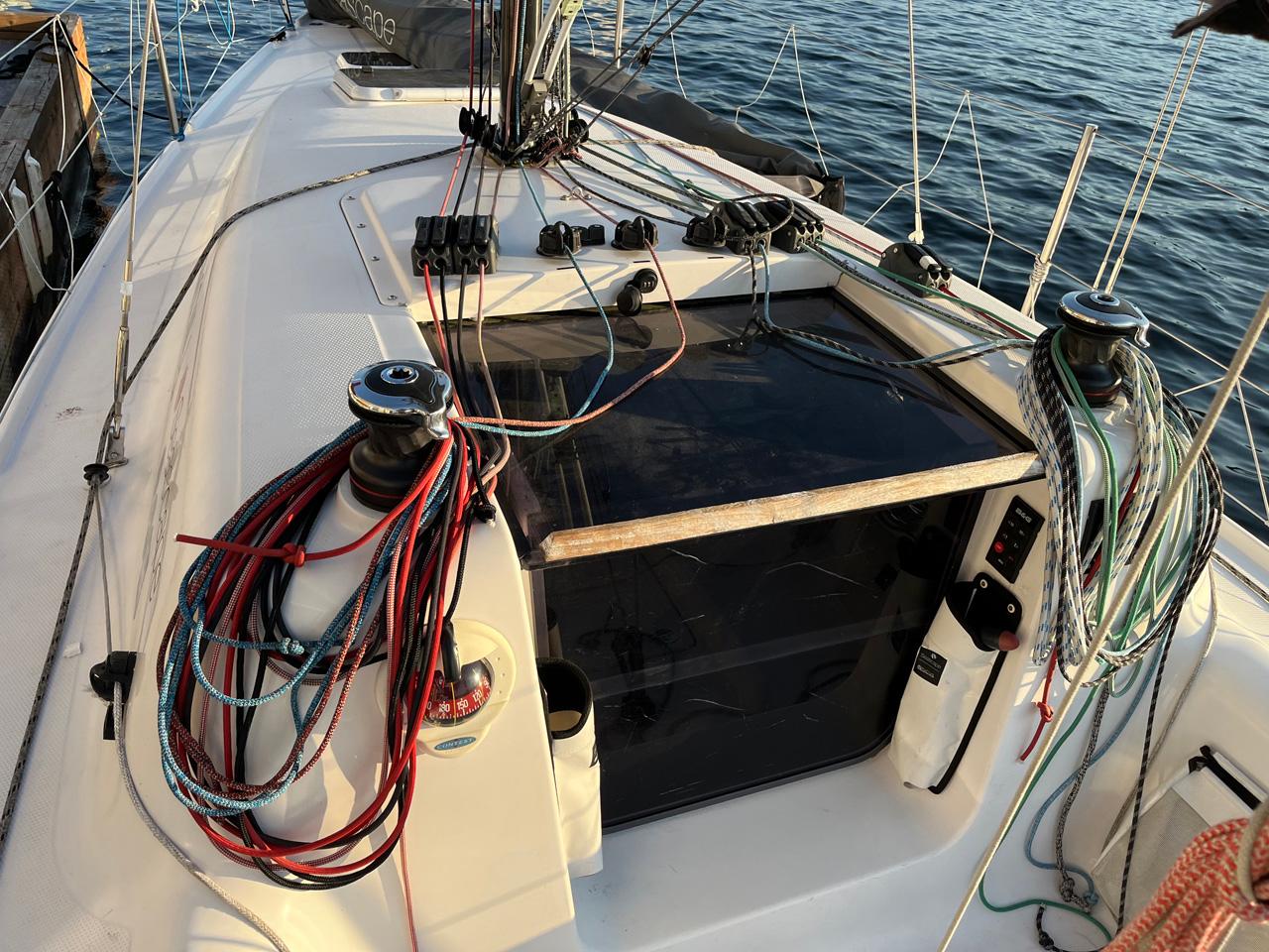 Sailboat deck with colorful ropes and winches, Seascape 27 model, 2018, on calm water.