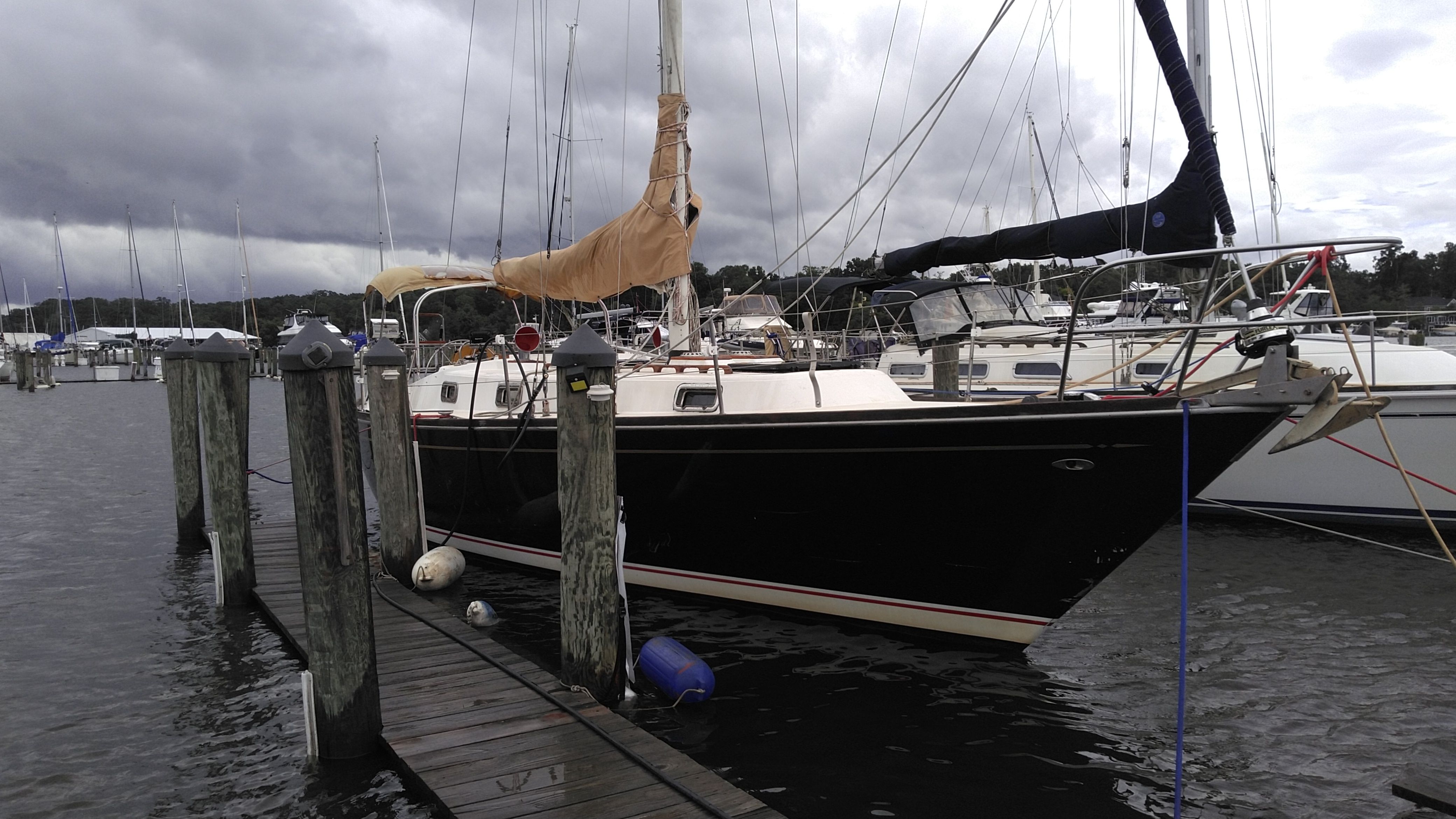 1978 Tartan 37 sailboat docked in harbor under cloudy skies.