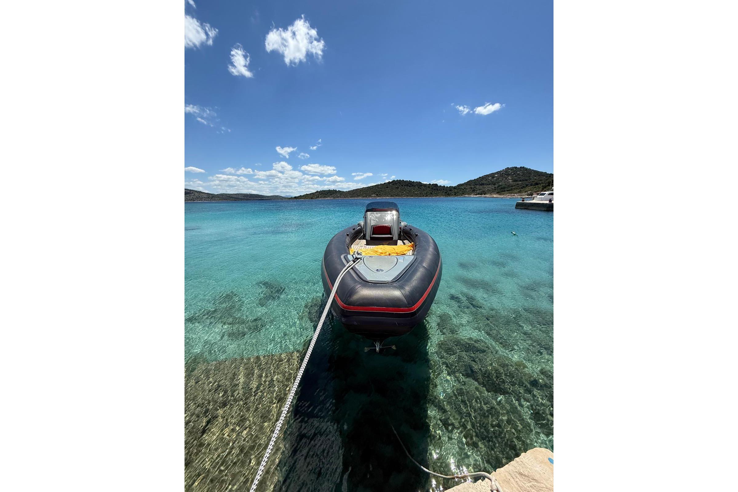 Technohull seaDNA 999 boat docked in clear turquoise water, 2021 model.