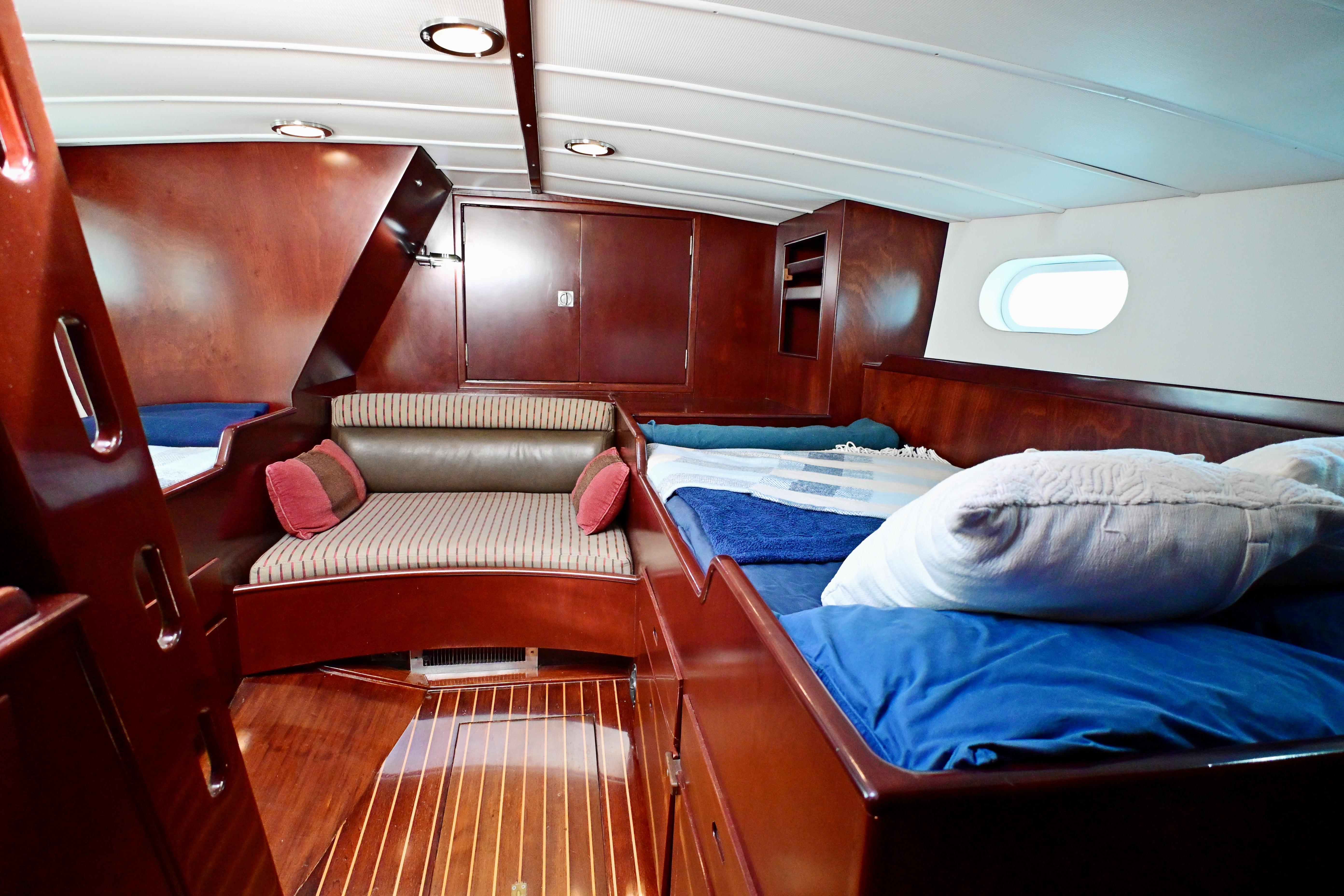 Luxurious wooden interior of a 1968 Abeking & Rasmussen Tripp 74 yacht cabin.
