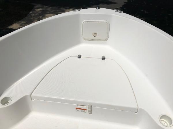 2003 Wellcraft 180 Fisherman boat interior, featuring a clean white deck and storage compartment.