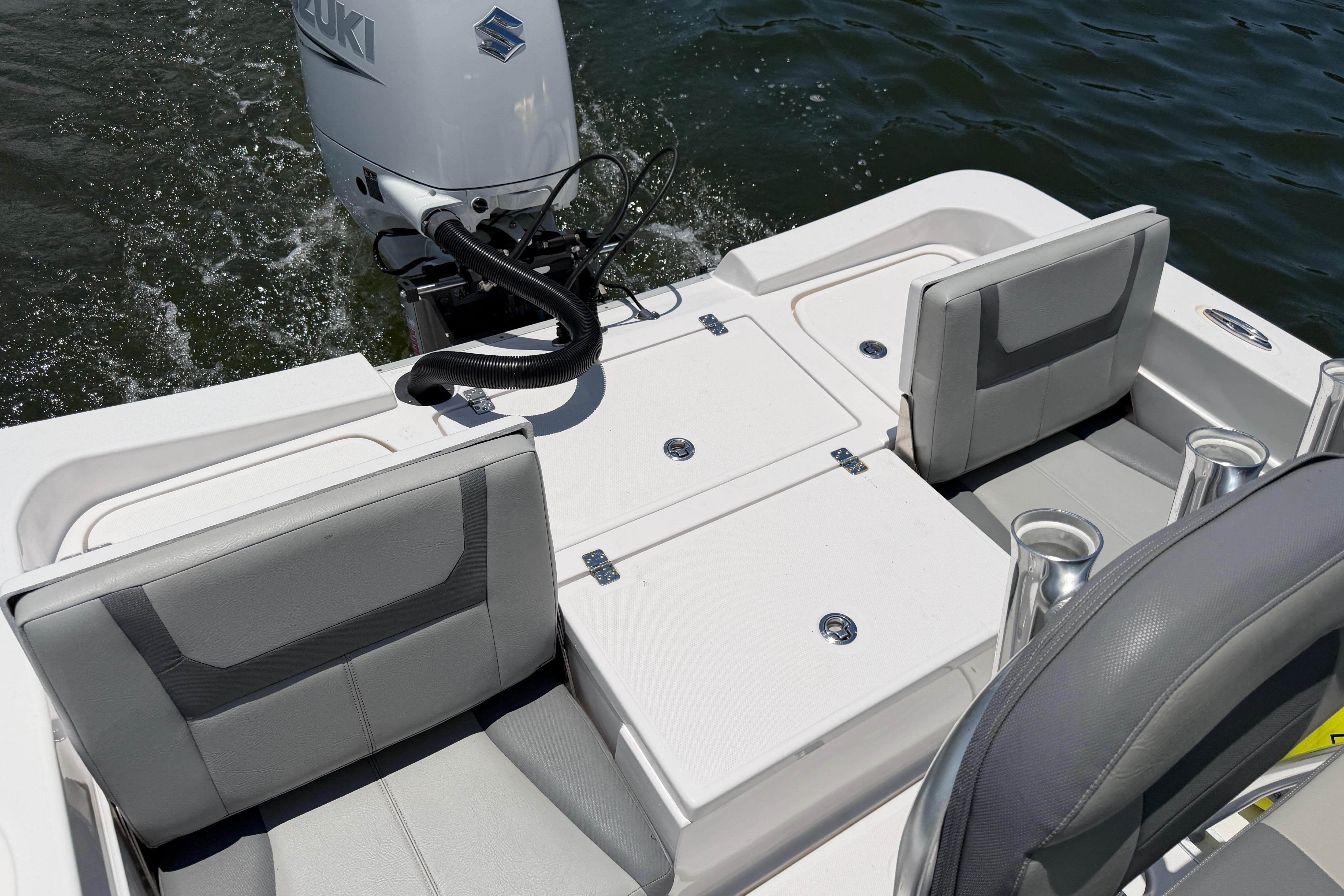 2022 Aquasport 230 Pro Bay boat interior with Suzuki outboard motor on water.