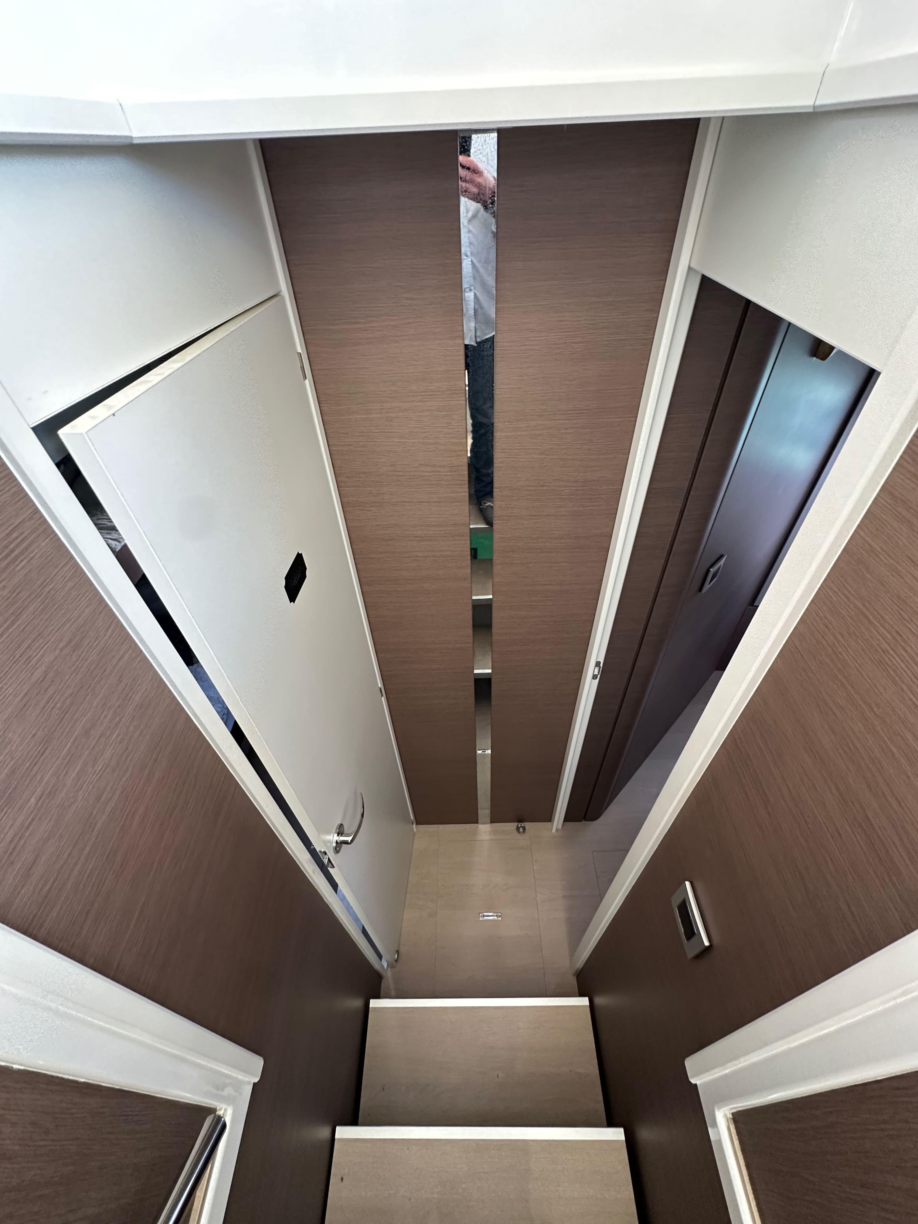 Interior view of a 2021 Bali 4.8 yacht, featuring a narrow hallway and modern design.