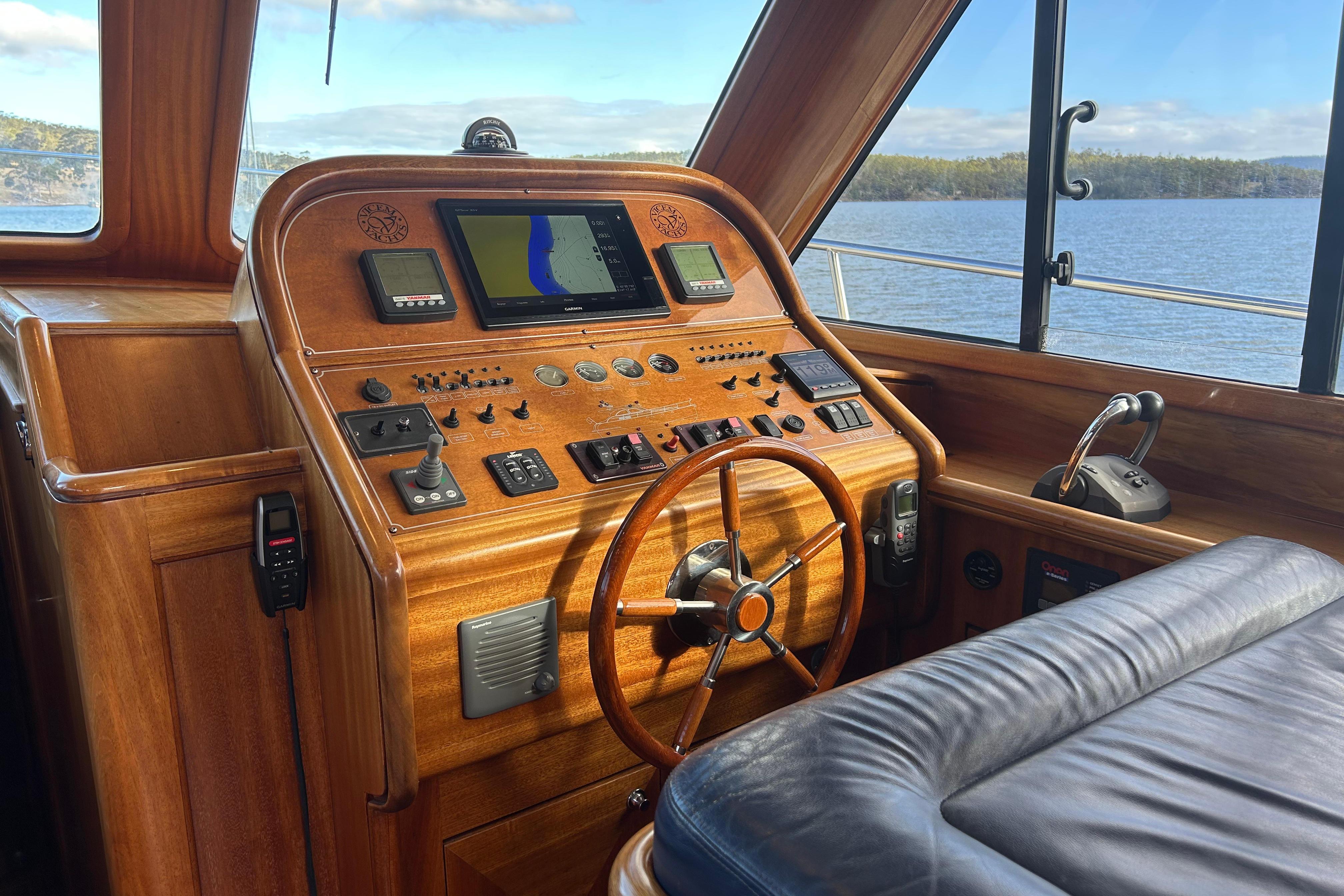 Helm of 2008 Vicem 44 yacht with wooden dashboard and navigation equipment.