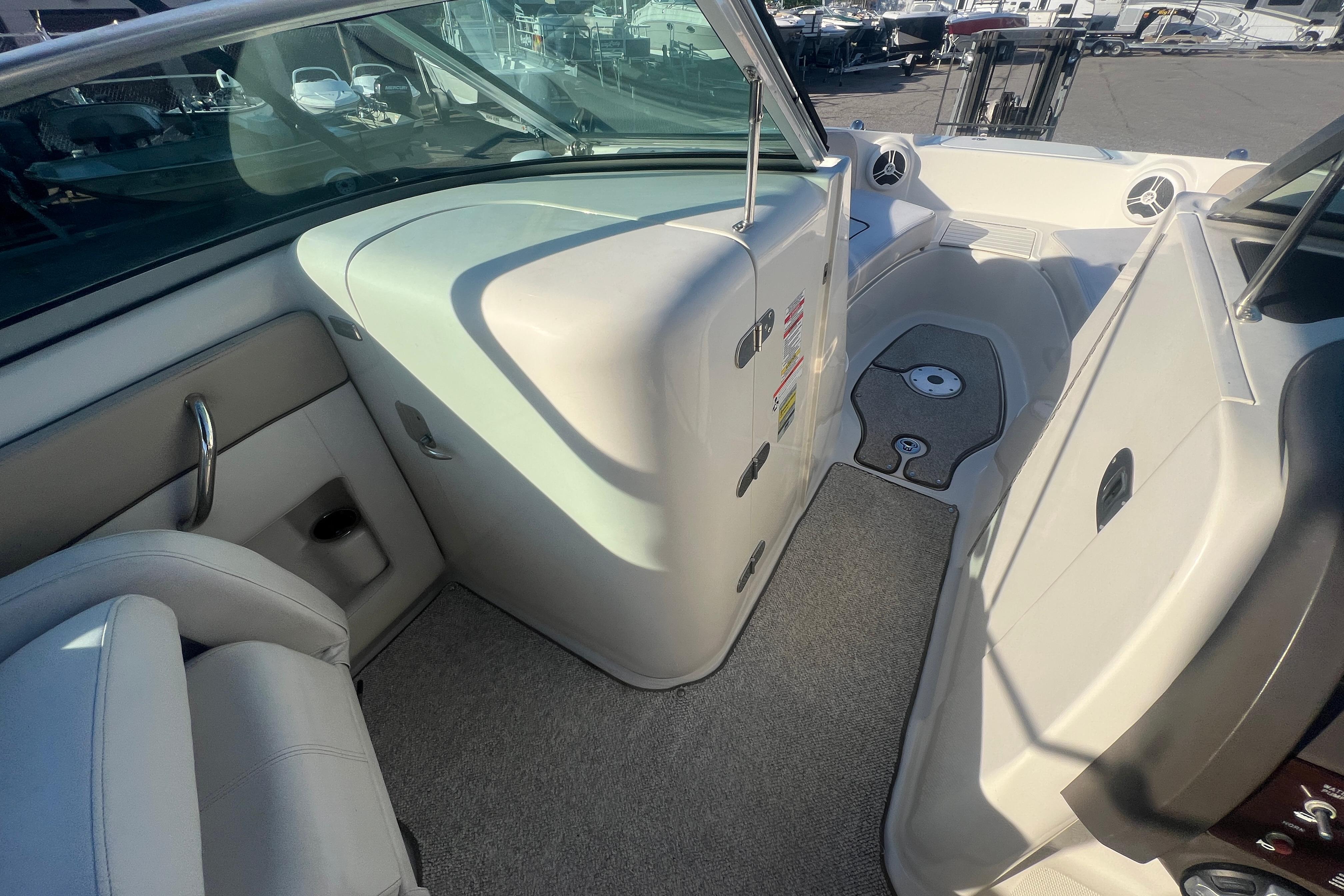 2009 Sea Ray 210 Sundeck interior with seating and storage, showcasing sleek design and functionality.