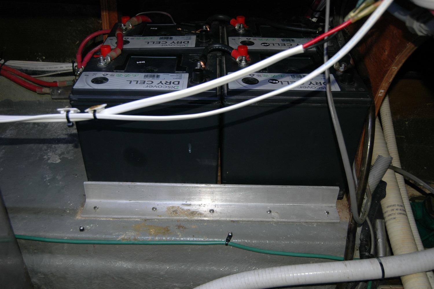 Battery compartment of a 1987 Bertram 33 Sport Fisherman boat, featuring dry cell batteries.