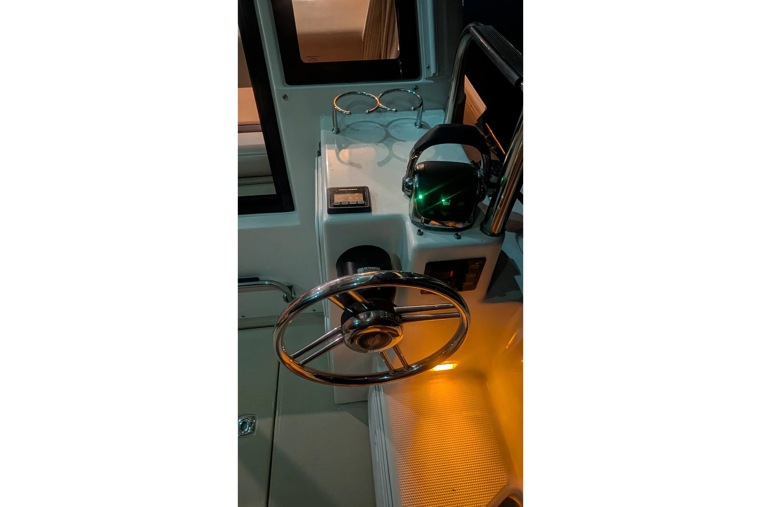 2015 Ranger Tugs R-29 S helm with illuminated controls and steering wheel.