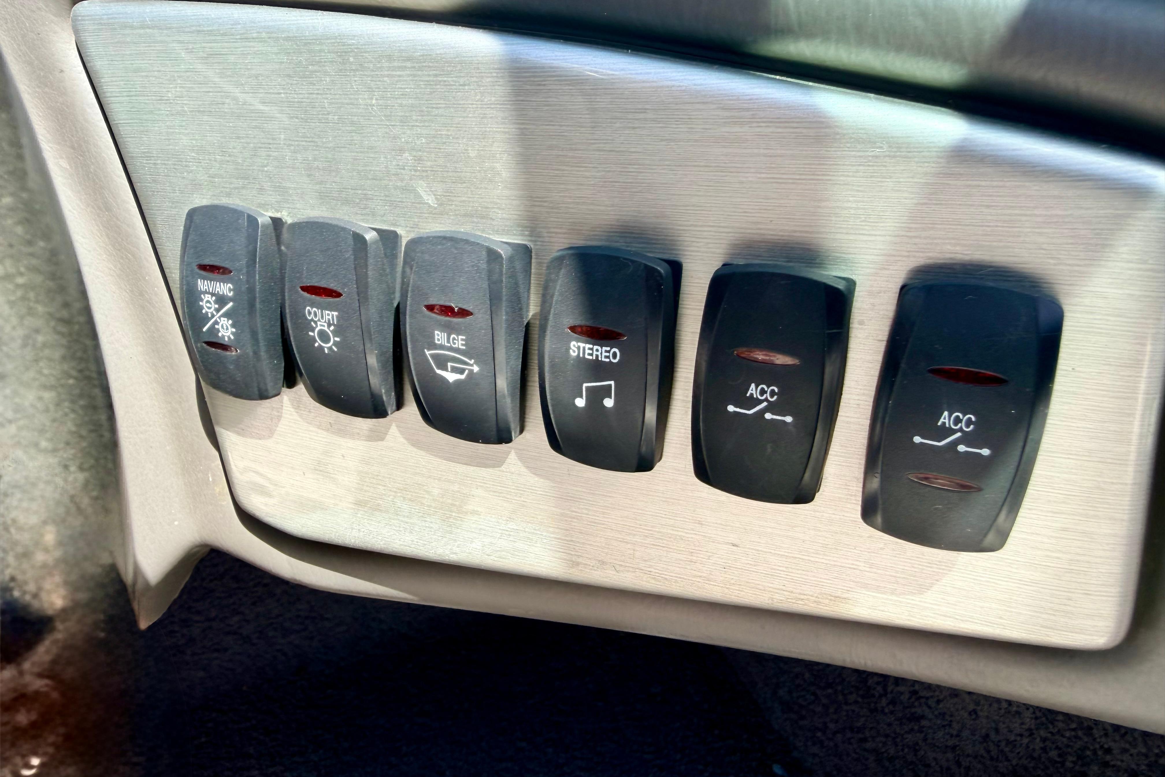 Dashboard switches of a 2008 Moomba Outback V boat, including navigation and stereo controls.