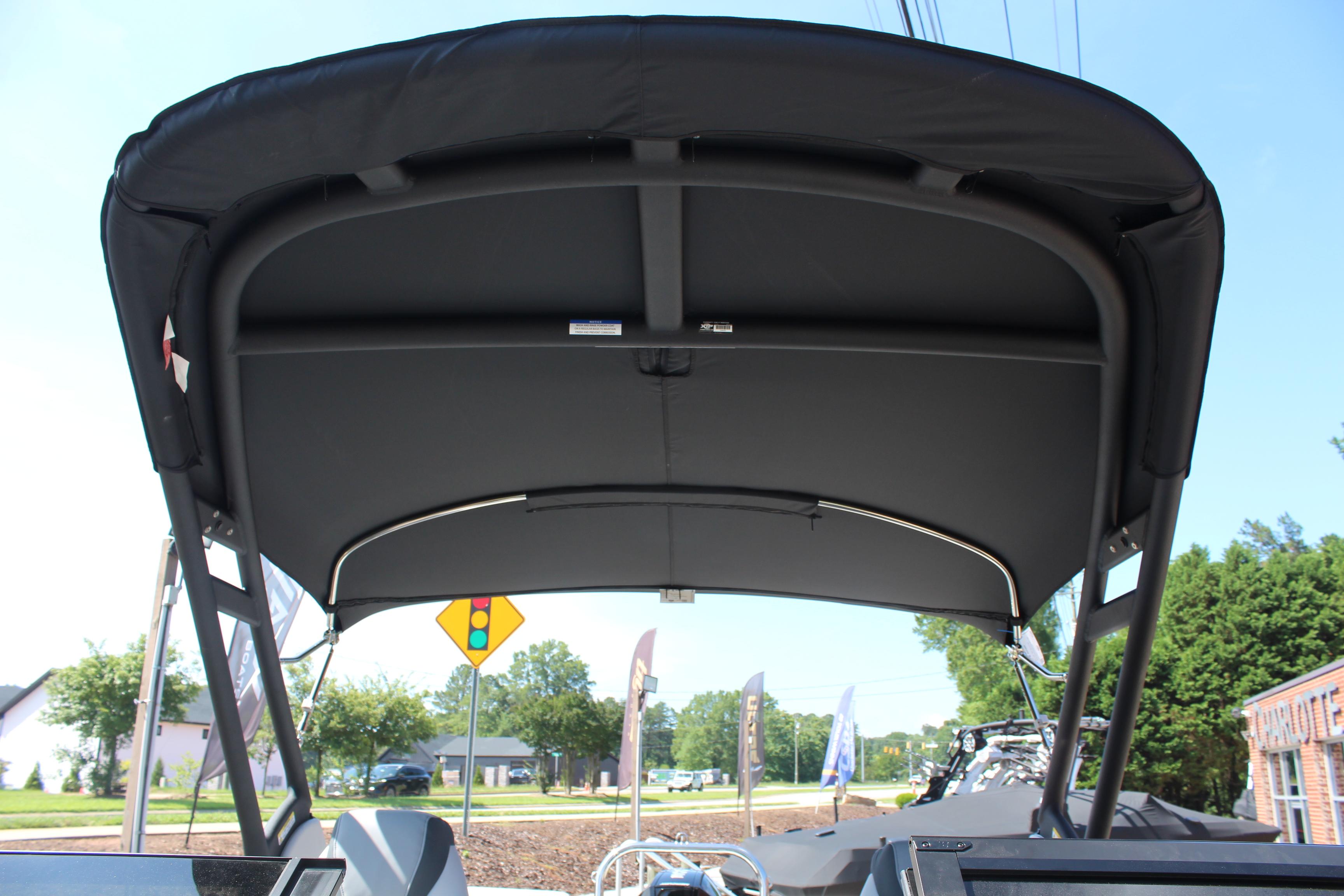 2025 Tahoe Pontoon Cascade Quad Lounge Windshield with black canopy, viewed from below.
