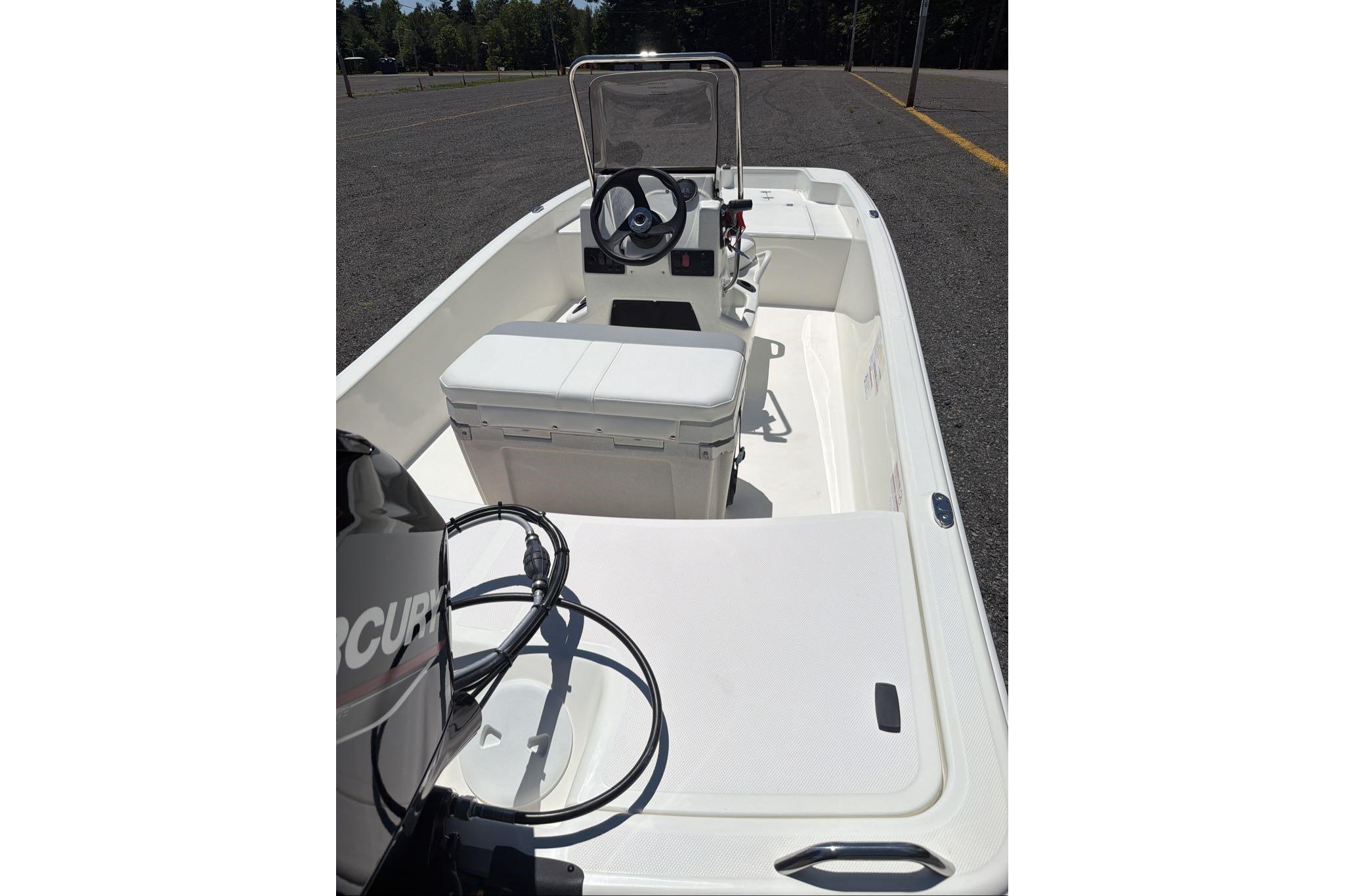 2026 Mako Pro Skiff 15 CC boat interior with steering console and seating.