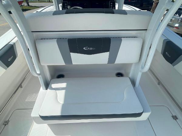 2023 Robalo R270 boat seating area with cup holders and cushioned backrest.