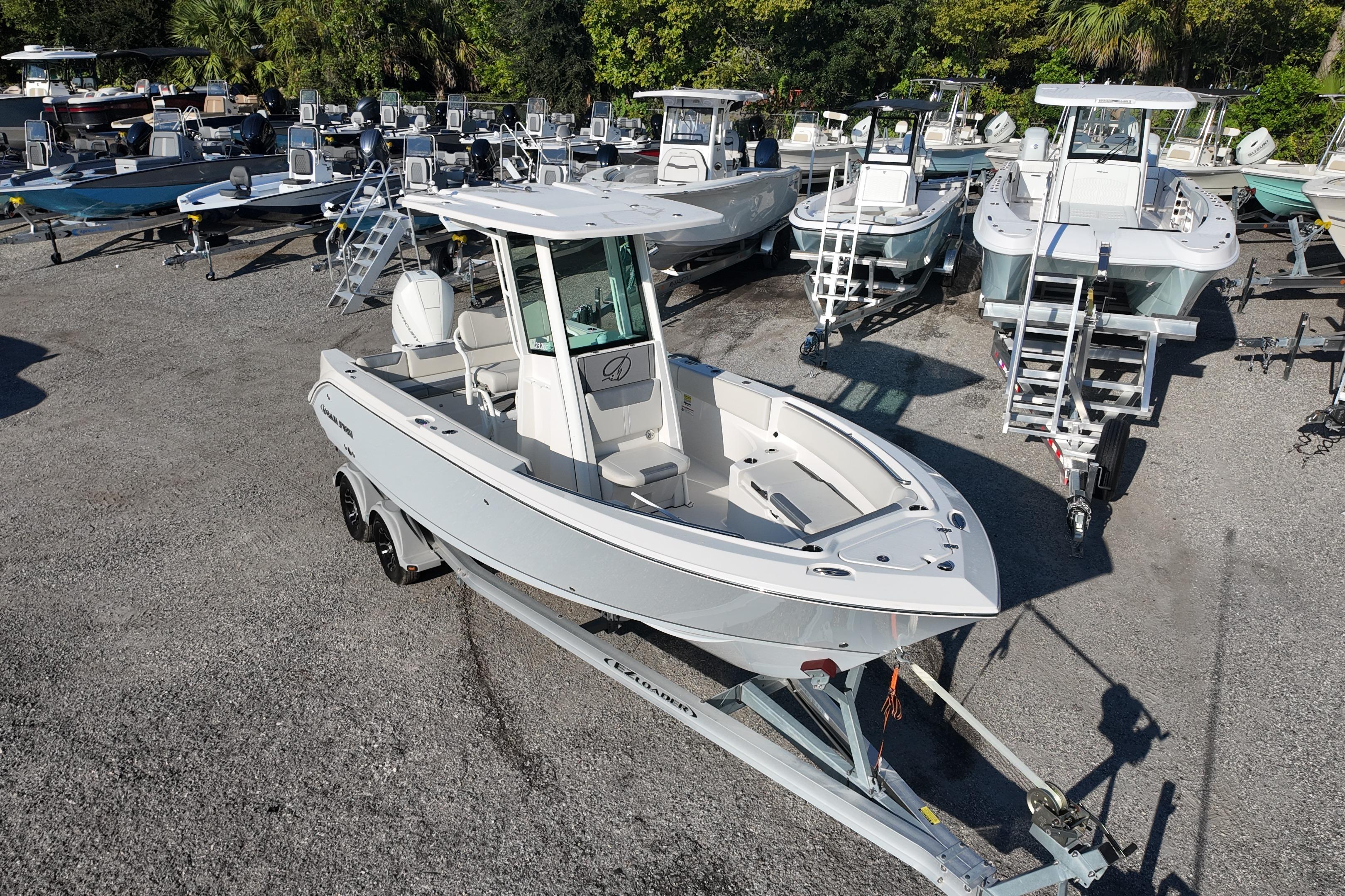 2026 Sailfish 232 CC boat on trailer in a marina with multiple boats.