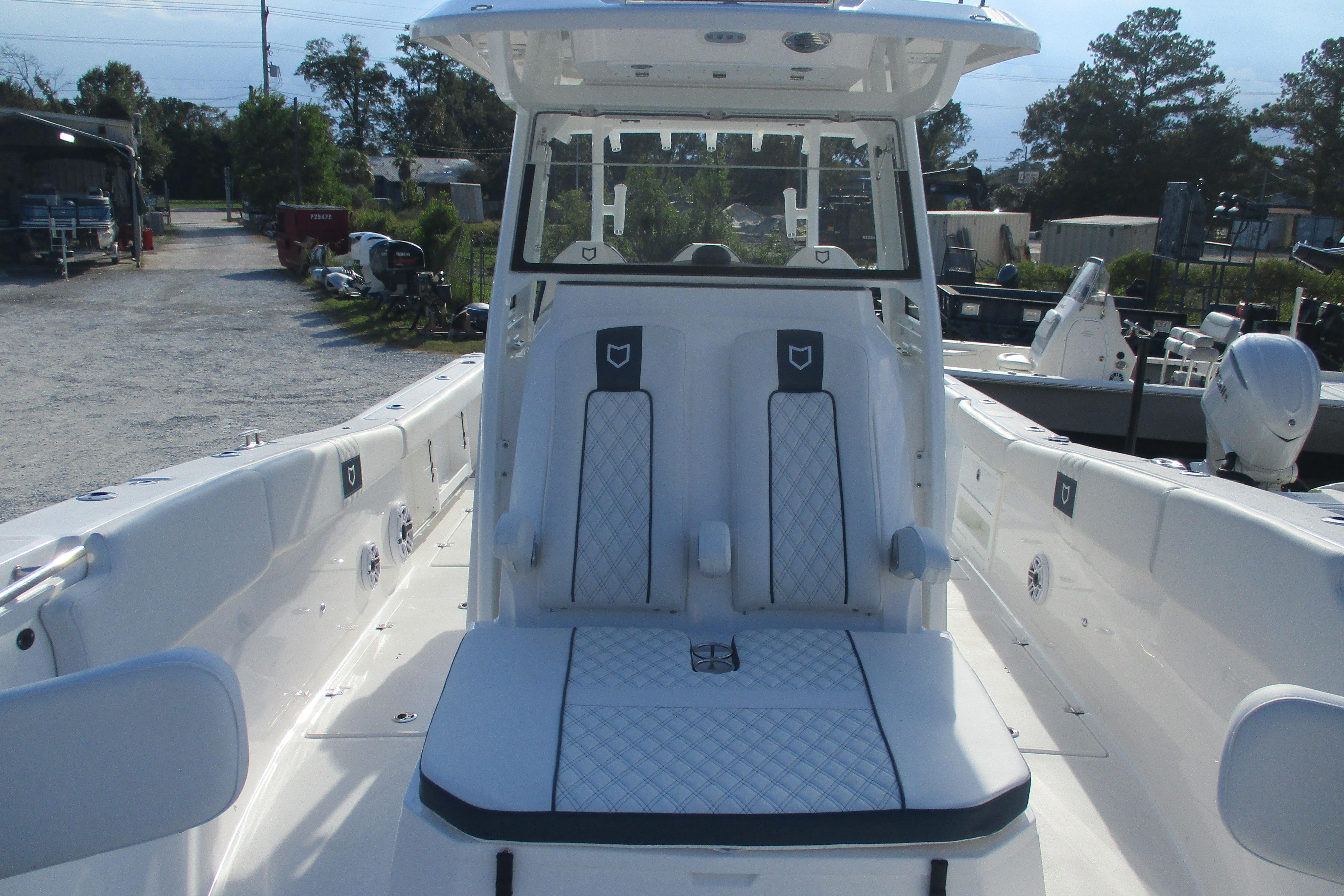2026 Sea Fox 328 Commander boat interior with white seating and console.