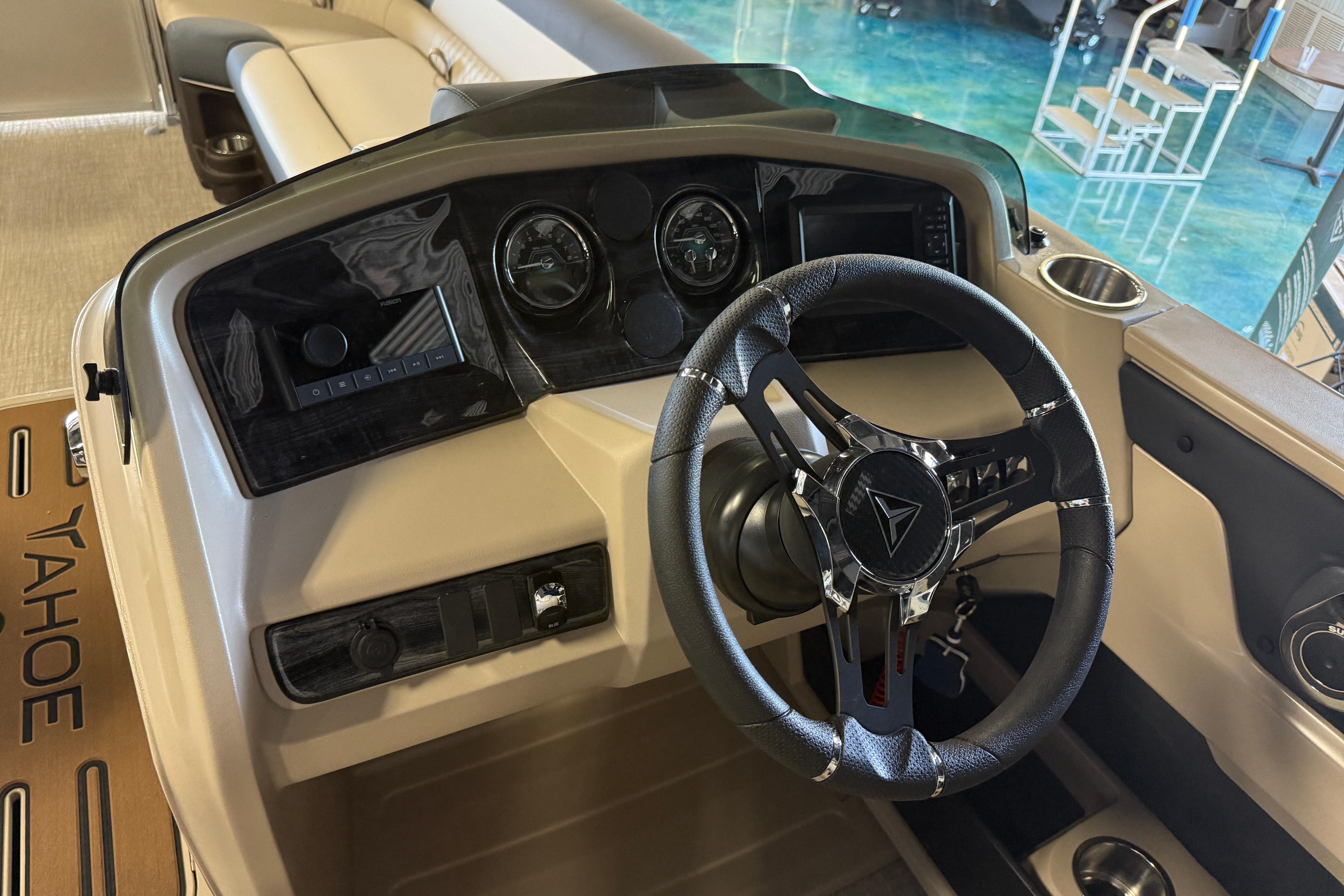 2026 Tahoe Pontoon LTZ Entertainer dashboard with steering wheel and control panel.