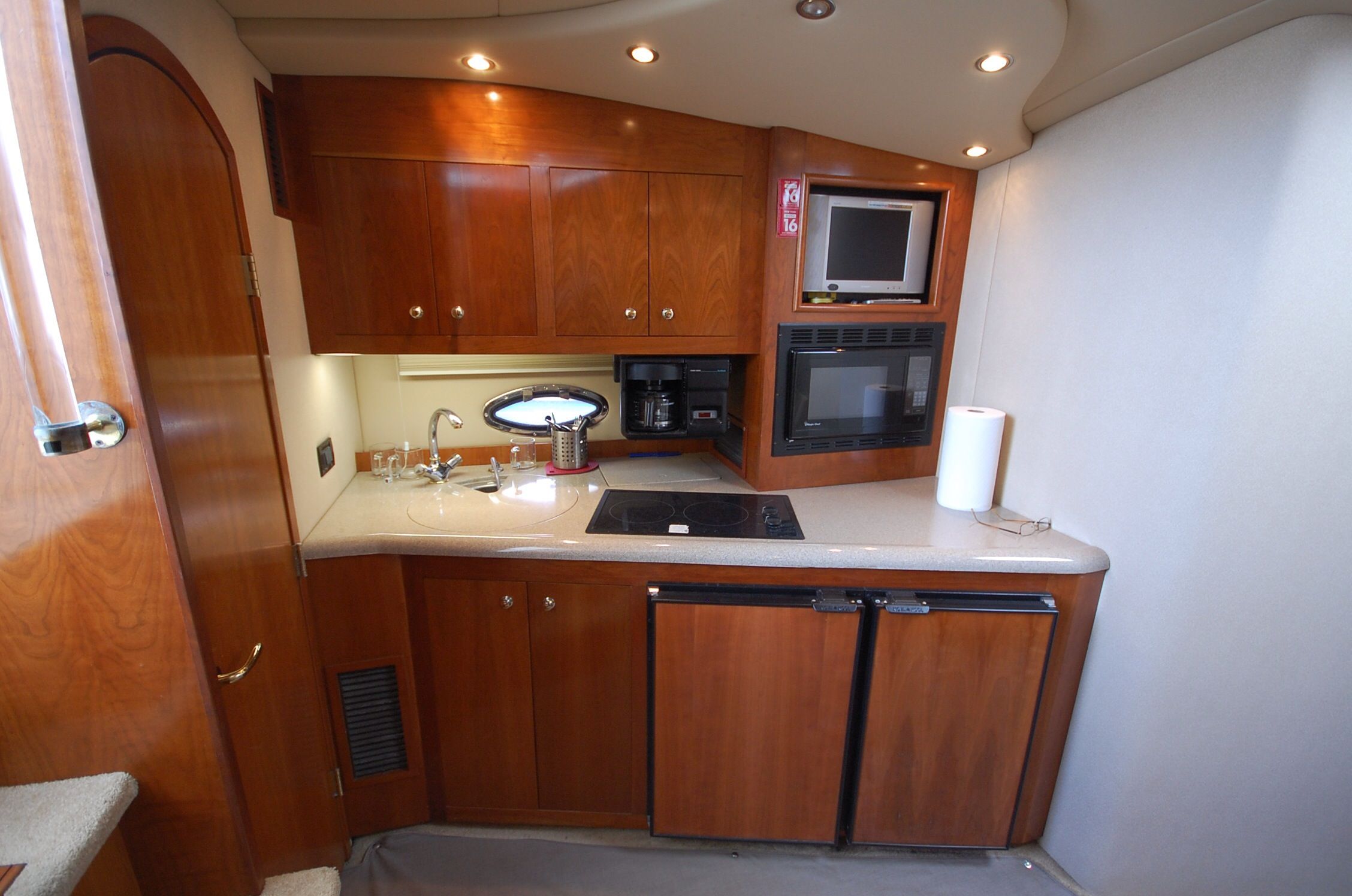 2004 Cruisers Yachts 3970 interior with kitchen and wooden cabinets.