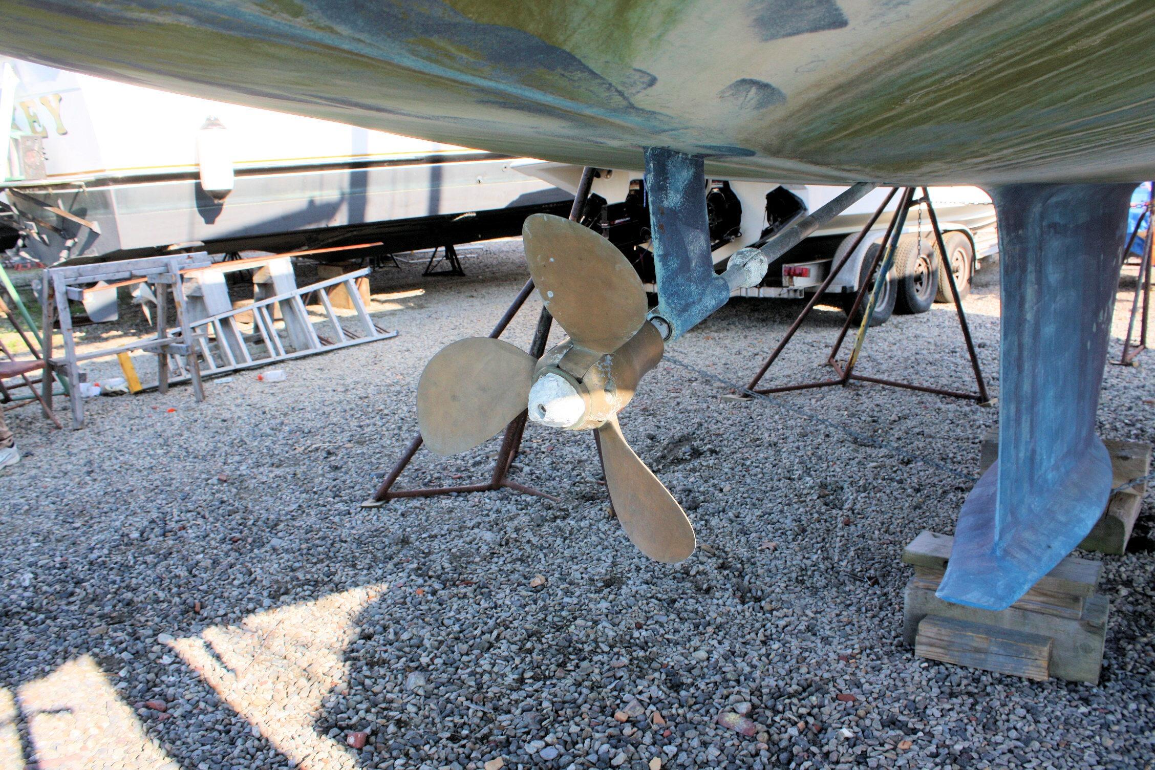 1987 Ericson 38-200 sailboat propeller and keel on gravel, in dry dock.