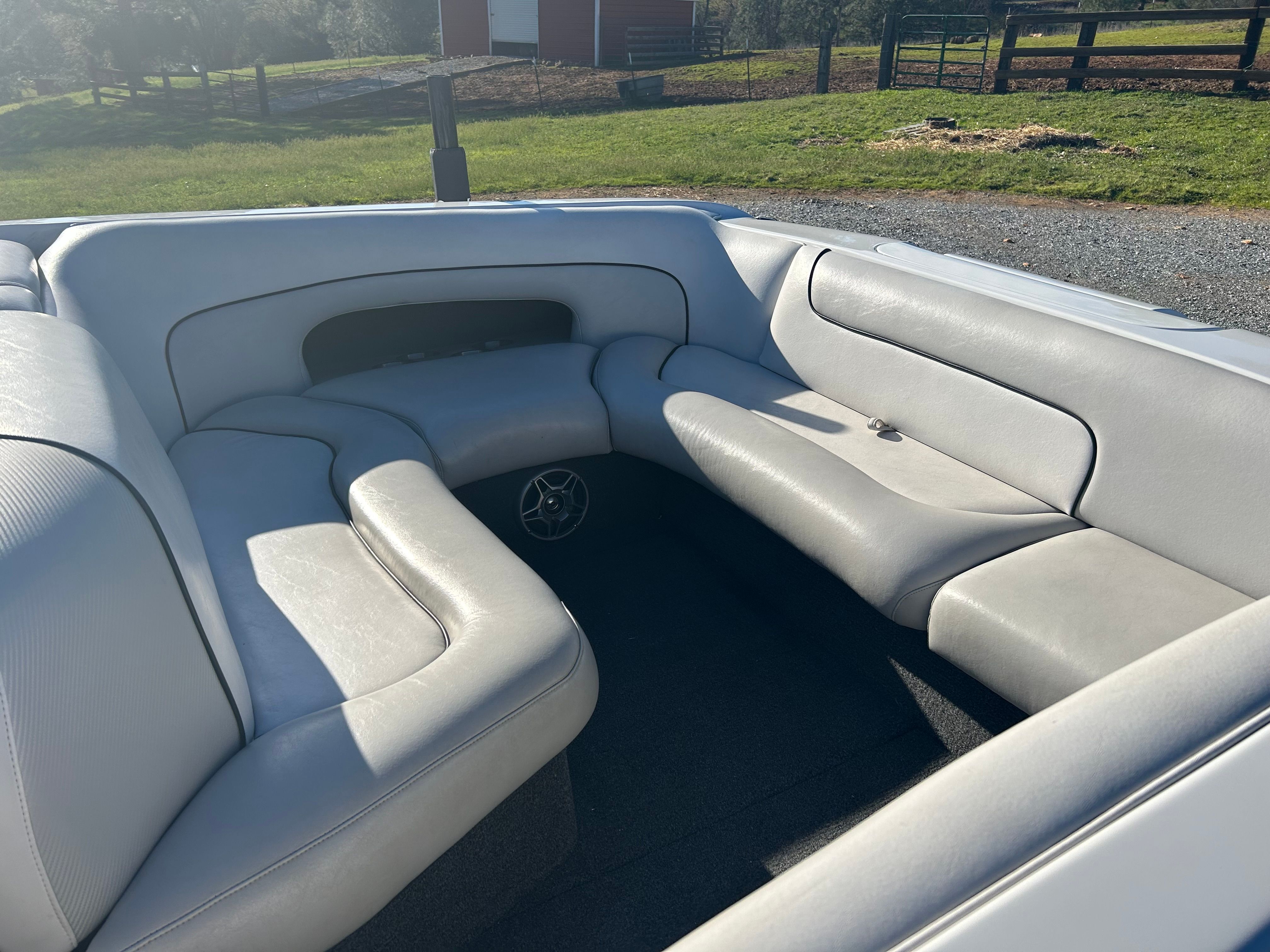 The image shows the interior of a boat with gray upholstered seats.