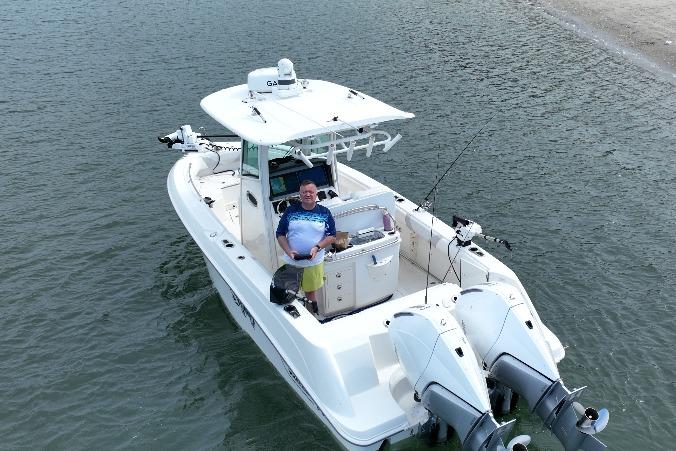 2023 Boston Whaler 250 Outrage boat on water with person at helm.