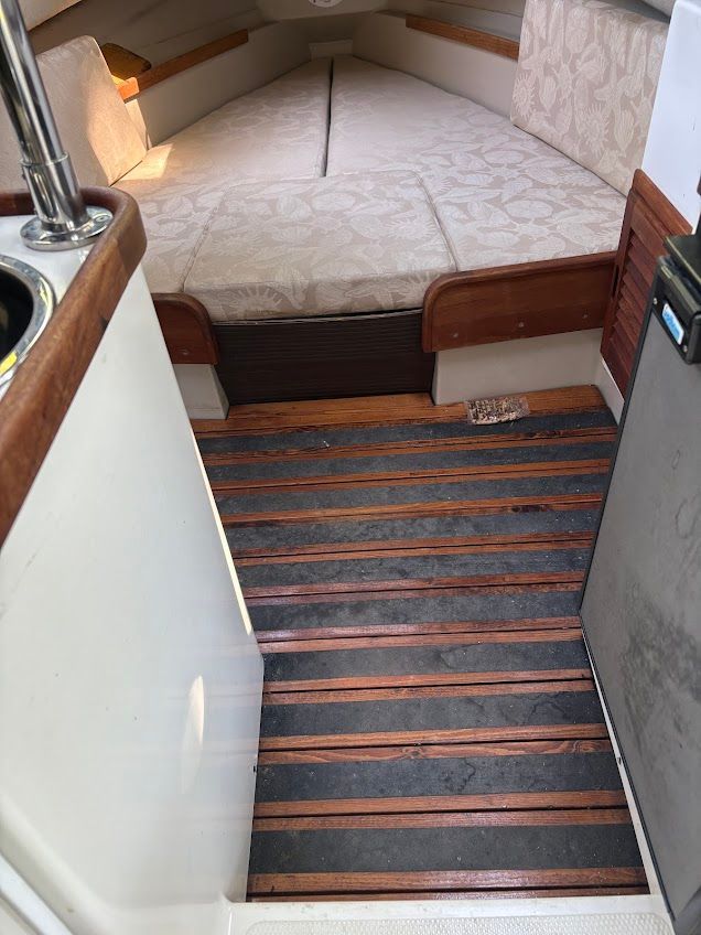 The image shows the interior of a 2007 Ranger Tugs R-21 EC with wooden flooring and cushioned seating.