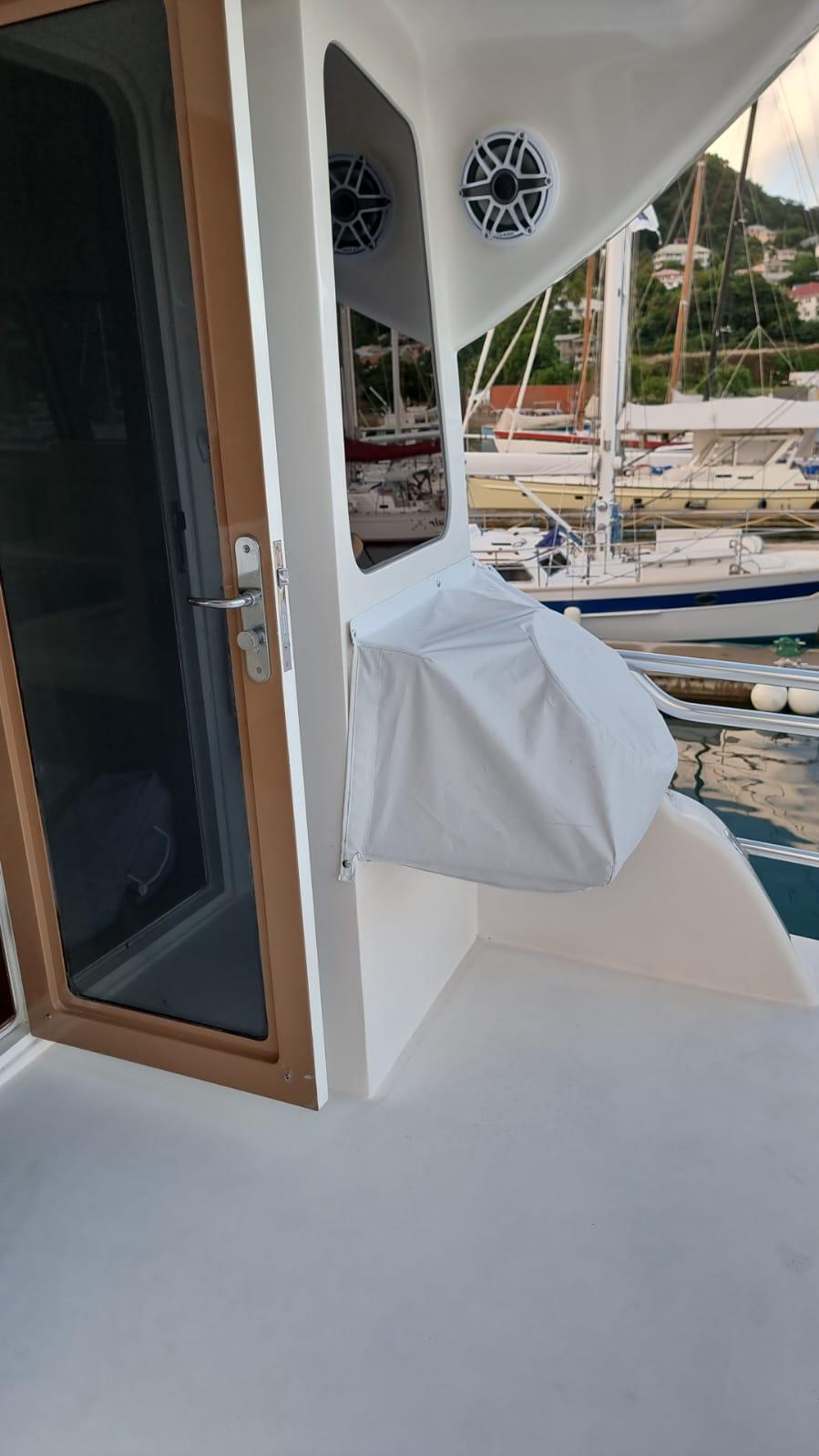 2009 Bertram 700 Enclosed yacht deck with door and covered equipment.