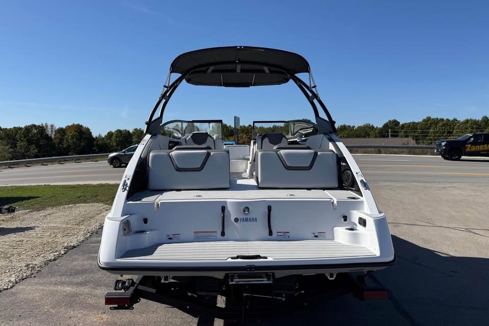 2026 Yamaha AR250 boat, rear view, parked outdoors under clear blue sky.